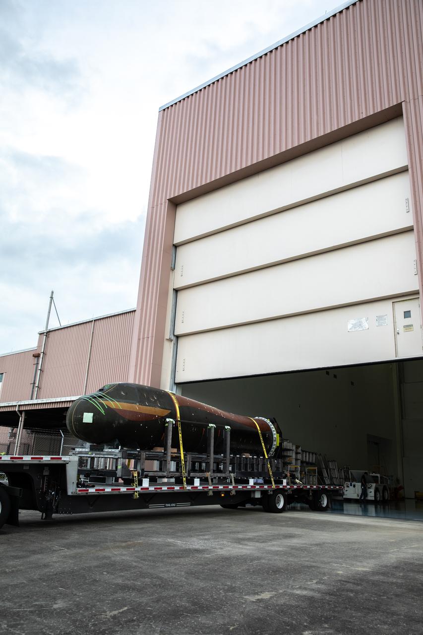 Sierra Nevada Corporation’s (SNC) Dream Chaser pressure test article arrives by flatbed truck at the Space Station Processing Facility at NASA’s Kennedy Space Center in Florida on June 3, 2020, from Louisville, Colorado. The test article is similar to the actual pressurized cabin being used in the Dream Chaser spaceplane for Commercial Resupply Services-2 (CRS-2) missions. NASA selected Dream Chaser to provide cargo delivery, return and disposal service for the International Space Station under the CRS-2 contract. The test article will remain at Kennedy while SNC engineers use it to develop and verify refurbishment operations that will be used on Dream Chaser between flights.