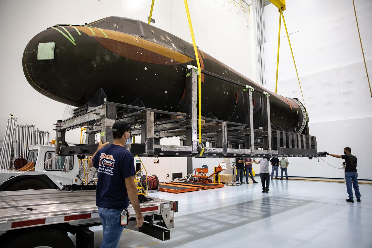 Inside the low bay of the Space Station Processing Facility at NASA’s Kennedy Space Center in Florida, Sierra Nevada Corporation’s (SNC) Dream Chaser pressure test article on its support structure is lifted up by crane from the flatbed truck on June 3, 2020, for its move into the high bay. The test article was shipped from Louisville, Colorado. It is similar to the actual pressurized cabin being used in the Dream Chaser spaceplane for Commercial Resupply Services-2 (CRS-2) missions. NASA selected Dream Chaser to provide cargo delivery, return and disposal service for the International Space Station under the CRS-2 contract. The test article will remain at Kennedy while SNC engineers use it to develop and verify refurbishment operations that will be used on Dream Chaser between flights.