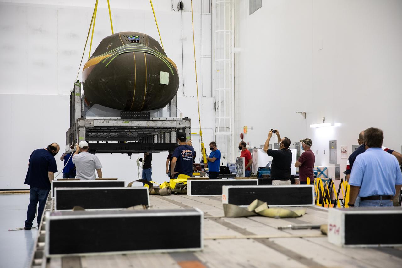 Inside the low bay of the Space Station Processing Facility at NASA’s Kennedy Space Center in Florida, Sierra Nevada Corporation’s (SNC) Dream Chaser pressure test article on its support structure is lifted up by crane from the flatbed truck on June 3, 2020, for its move into the high bay. The test article was shipped from Louisville, Colorado. It is similar to the actual pressurized cabin being used in the Dream Chaser spaceplane for Commercial Resupply Services-2 (CRS-2) missions. NASA selected Dream Chaser to provide cargo delivery, return and disposal service for the International Space Station under the CRS-2 contract. The test article will remain at Kennedy while SNC engineers use it to develop and verify refurbishment operations that will be used on Dream Chaser between flights.