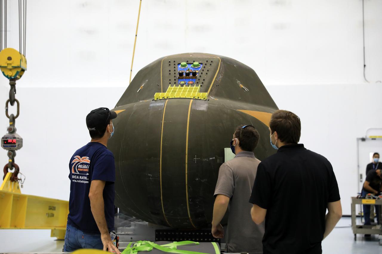 Inside the low bay of the Space Station Processing Facility at NASA’s Kennedy Space Center in Florida, workers monitor the progress as Sierra Nevada Corporation’s (SNC) Dream Chaser pressure test article on its support structure is lowered by crane away from the flatbed truck on June 3, 2020, for its move into the high bay. The test article was shipped from Louisville, Colorado. It is similar to the actual pressurized cabin being used in the Dream Chaser spaceplane for Commercial Resupply Services-2 (CRS-2) missions. NASA selected Dream Chaser to provide cargo delivery, return and disposal service for the International Space Station under the CRS-2 contract. The test article will remain at Kennedy while SNC engineers use it to develop and verify refurbishment operations that will be used on Dream Chaser between flights.