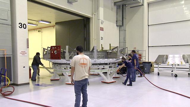 Inside the Neil Armstrong Operations and Checkout Building at NASA's Kennedy Space Center in Florida, the Artemis II crew module adapter (CMA) is being relocated from the clean room to the Pressure Proof Cell for additional testing and maintenance. The CMA connects the crew module to the service module. Artemis II is the first crewed mission in a series of missions to the Moon and on to Mars. Artemis II will confirm all of the Orion spacecraft’s systems operate as designed in the actual environment of deep space with astronauts aboard.