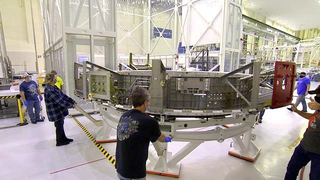 Inside the Neil Armstrong Operations and Checkout Building at NASA's Kennedy Space Center in Florida, the Artemis II crew module adapter (CMA) is being relocated from the clean room to the Pressure Proof Cell for additional testing and maintenance. The CMA connects the crew module to the service module. Artemis II is the first crewed mission in a series of missions to the Moon and on to Mars. Artemis II will confirm all of the Orion spacecraft’s systems operate as designed in the actual environment of deep space with astronauts aboard.