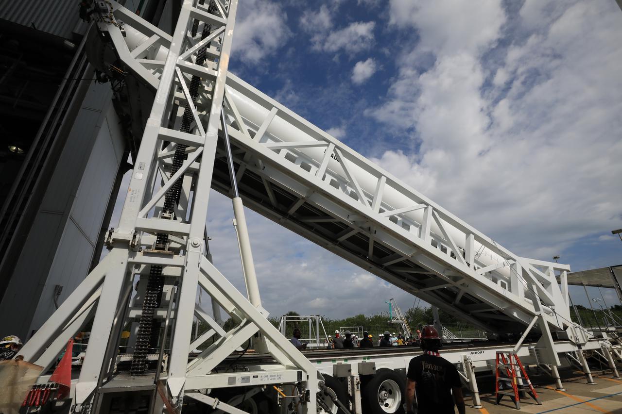 A lifting device raises the third of four solid rocket boosters (SRB) for the United Launch Alliance Atlas V 541 rocket into the vertical position at the Vertical Integration Facility (VIF) at Space Launch Complex 41 at Cape Canaveral Air Force Station (CCAFS) in Florida on June 8, 2020. The SRB will be lifted up and mated to the Atlas V booster in the VIF. NASA’s Mars 2020 mission with the Perseverance rover is scheduled to launch on July 20, 2020, atop the Atlas V rocket from Pad 41. The rover is part of NASA’s Mars Exploration Program, a long-term effort of robotic exploration of the Red Planet. The rover’s seven instruments will search for habitable conditions in the ancient past and signs of past microbial life on Mars. The Launch Services Program at Kennedy is responsible for launch management.