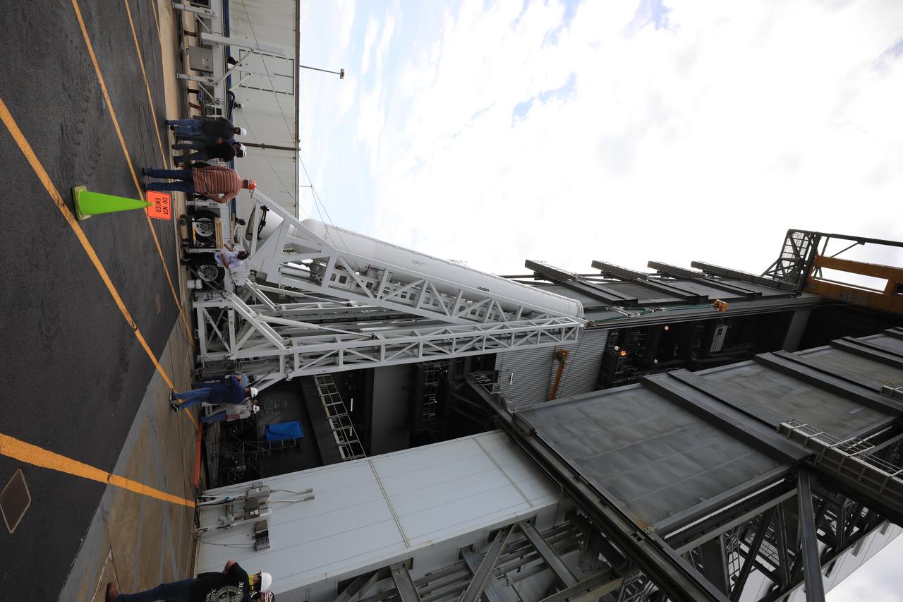 A lifting device is used to raise the third of four solid rocket boosters (SRB) for the United Launch Alliance Atlas V 541 rocket into the vertical position at the Vertical Integration Facility (VIF) at Space Launch Complex 41 at Cape Canaveral Air Force Station (CCAFS) in Florida on June 8, 2020. The SRB will be lifted up and mated to the Atlas V booster in the VIF. NASA’s Mars 2020 mission with the Perseverance rover is scheduled to launch on July 20, 2020, atop the Atlas V rocket from Pad 41. The rover is part of NASA’s Mars Exploration Program, a long-term effort of robotic exploration of the Red Planet. The rover’s seven instruments will search for habitable conditions in the ancient past and signs of past microbial life on Mars. The Launch Services Program at Kennedy is responsible for launch management.