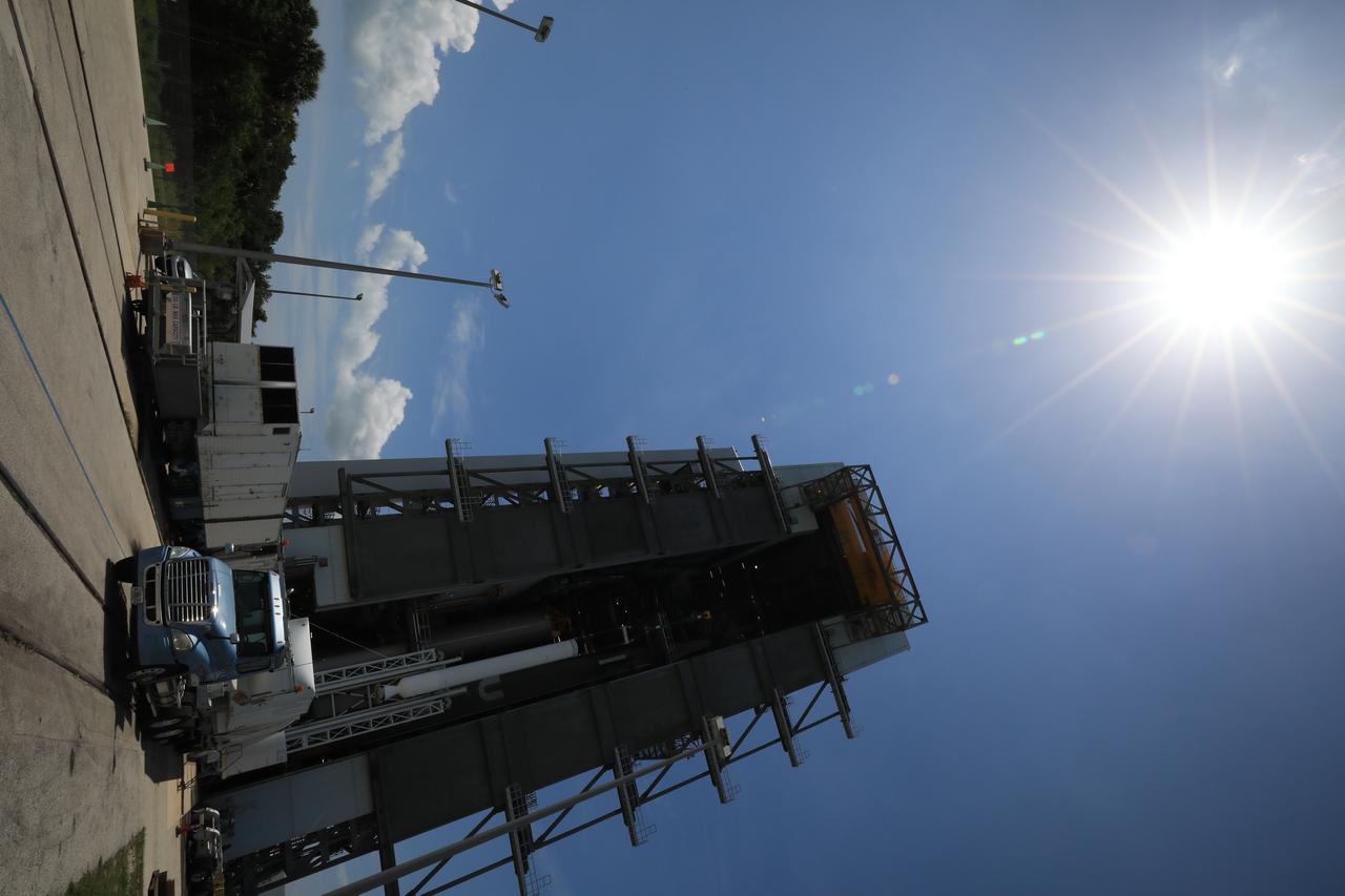 A crane is used to lift the third of four solid rocket boosters (SRB) for the United Launch Alliance Atlas V 541 rocket into the Vertical Integration Facility (VIF) at Space Launch Complex 41 at Cape Canaveral Air Force Station (CCAFS) in Florida on June 8, 2020. The SRB will be lifted up and mated to the Atlas V booster in the VIF. NASA’s Mars 2020 mission with the Perseverance rover is scheduled to launch on July 20, 2020, atop the Atlas V rocket from Pad 41. The rover is part of NASA’s Mars Exploration Program, a long-term effort of robotic exploration of the Red Planet. The rover’s seven instruments will search for habitable conditions in the ancient past and signs of past microbial life on Mars. The Launch Services Program at Kennedy is responsible for launch management.