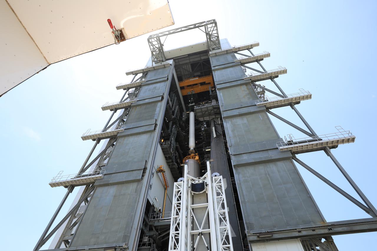 A crane is used to lift the third of four solid rocket boosters (SRB) for the United Launch Alliance Atlas V 541 rocket into the Vertical Integration Facility (VIF) at Space Launch Complex 41 at Cape Canaveral Air Force Station (CCAFS) in Florida on June 8, 2020. The SRB will be lifted up and mated to the Atlas V booster in the VIF. NASA’s Mars 2020 mission with the Perseverance rover is scheduled to launch on July 20, 2020, atop the Atlas V rocket from Pad 41. The rover is part of NASA’s Mars Exploration Program, a long-term effort of robotic exploration of the Red Planet. The rover’s seven instruments will search for habitable conditions in the ancient past and signs of past microbial life on Mars. The Launch Services Program at Kennedy is responsible for launch management.