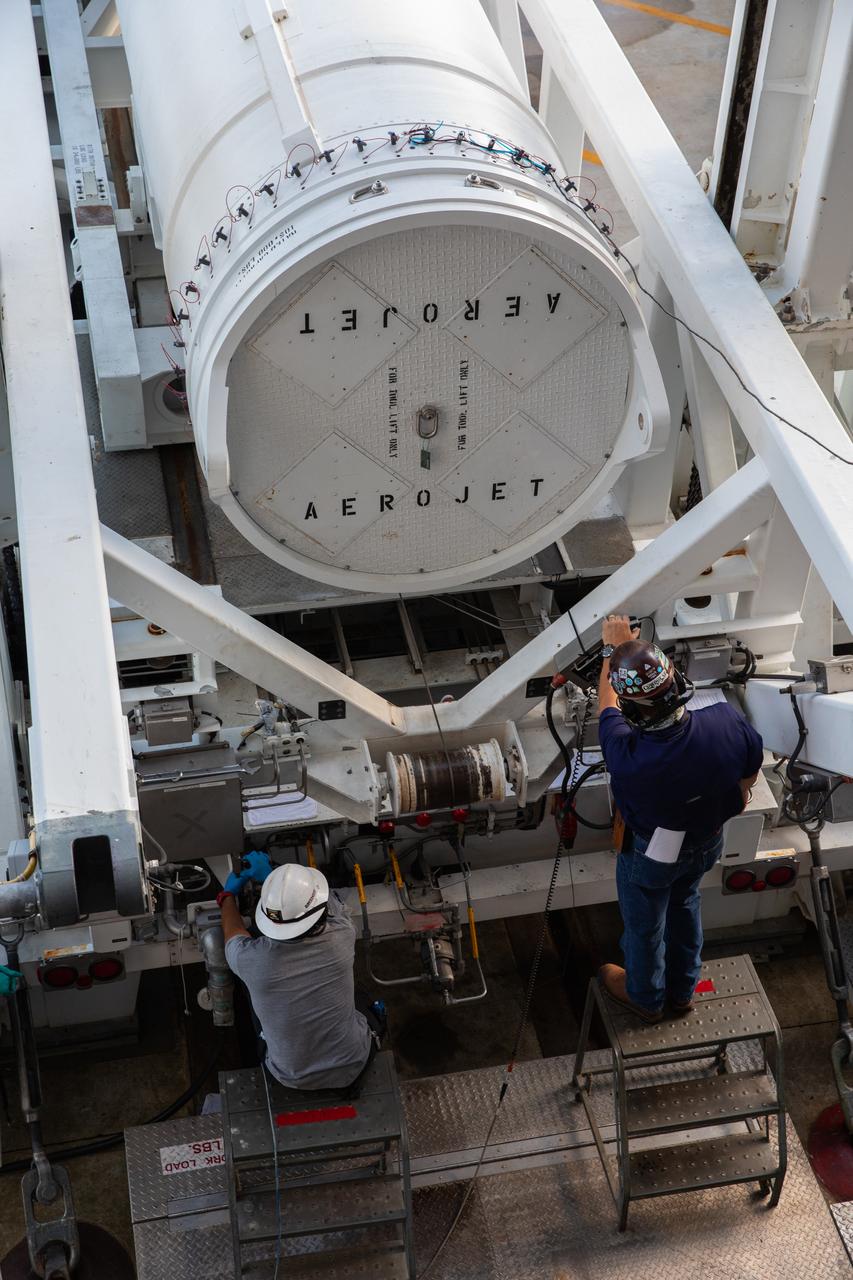 United Launch Alliance workers assist as a lifting device begins to raise the fourth and final solid rocket booster (SRB) for the United Launch Alliance Atlas V 541 rocket into the vertical position at the Vertical Integration Facility (VIF) at Space Launch Complex 41 at Cape Canaveral Air Force Station (CCAFS) in Florida on June 9, 2020. The SRB will be lifted up and mated to the Atlas V booster in the VIF. NASA’s Mars 2020 mission with the Perseverance rover is scheduled to launch in July 2020, atop the Atlas V rocket from Pad 41. The rover is part of NASA’s Mars Exploration Program, a long-term effort of robotic exploration of the Red Planet. The rover’s seven instruments will search for habitable conditions in the ancient past and signs of past microbial life on Mars. The Launch Services Program at Kennedy is responsible for launch management.