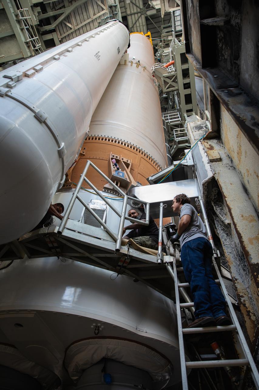 A United Launch Alliance worker is inside the Vertical Integration Facility (VIF) at Space Launch Complex 41 at Cape Canaveral Air Force Station (CCAFS) in Florida on June 9, 2020. A lifting device is used to raise the fourth and final solid rocket booster (SRB) for the United Launch Alliance Atlas V 541 rocket into the (VIF) where it will be mated to the booster. NASA’s Mars 2020 mission with the Perseverance rover is scheduled to launch in July 2020, atop the Atlas V rocket from Pad 41. The rover is part of NASA’s Mars Exploration Program, a long-term effort of robotic exploration of the Red Planet. The rover’s seven instruments will search for habitable conditions in the ancient past and signs of past microbial life on Mars. The Launch Services Program at Kennedy is responsible for launch management.