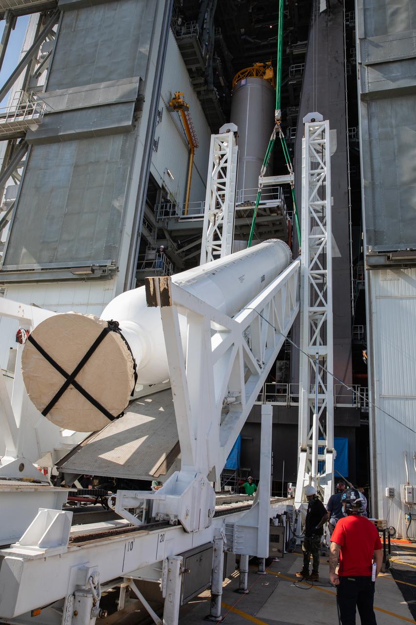 A lifting device raises the fourth and final solid rocket booster (SRB) for the United Launch Alliance Atlas V 541 rocket into the vertical position at the Vertical Integration Facility (VIF) at Space Launch Complex 41 at Cape Canaveral Air Force Station (CCAFS) in Florida on June 9, 2020. The SRB will be lifted up and mated to the Atlas V booster in the VIF. NASA’s Mars 2020 mission with the Perseverance rover is scheduled to launch in July 2020, atop the Atlas V rocket from Pad 41. The rover is part of NASA’s Mars Exploration Program, a long-term effort of robotic exploration of the Red Planet. The rover’s seven instruments will search for habitable conditions in the ancient past and signs of past microbial life on Mars. The Launch Services Program at Kennedy is responsible for launch management.