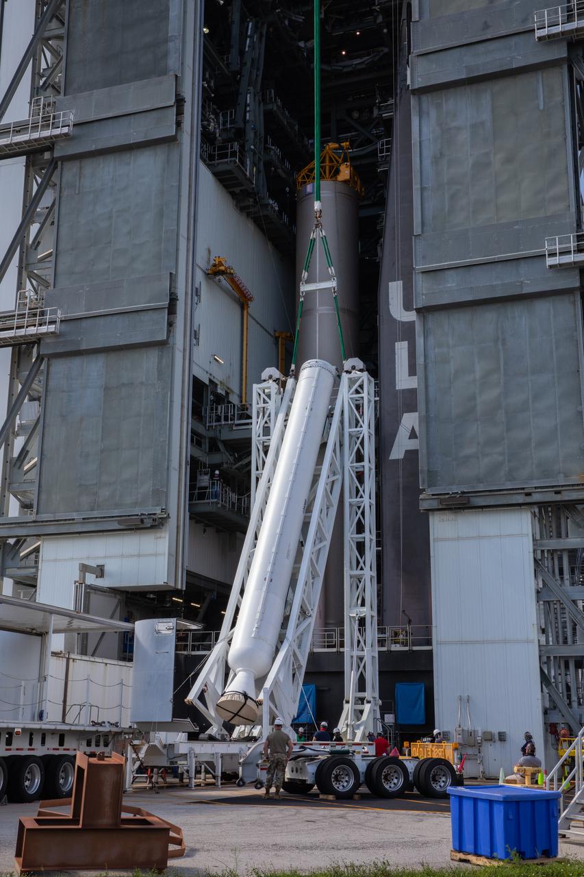 A lifting device raises the fourth and final solid rocket booster (SRB) for the United Launch Alliance Atlas V 541 rocket into the vertical position at the Vertical Integration Facility (VIF) at Space Launch Complex 41 at Cape Canaveral Air Force Station (CCAFS) in Florida on June 9, 2020. The SRB will be lifted up and mated to the Atlas V booster in the VIF. NASA’s Mars 2020 mission with the Perseverance rover is scheduled to launch in July 2020, atop the Atlas V rocket from Pad 41. The rover is part of NASA’s Mars Exploration Program, a long-term effort of robotic exploration of the Red Planet. The rover’s seven instruments will search for habitable conditions in the ancient past and signs of past microbial life on Mars. The Launch Services Program at Kennedy is responsible for launch management.