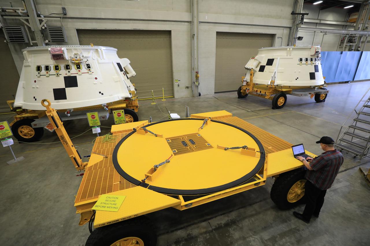 Inside the Booster Fabrication Facility at NASA's Kennedy Space Center in Florida, the Artemis I aft skirts for the agency's Space Launch System (SLS) rocket’s twin solid rocket boosters are being readied for their move to the Rotation, Processing and Surge Facility (RPSF) on June 9, 2020. In view at left is the left aft skirt assembly, and at right is the right aft skirt assembly. The aft skirts were refurbished by Northrop Grumman. They house the thrust vector control system, which controls 70 percent of the steering during initial ascent of the SLS rocket. The segments will remain in the RPSF until ready for stacking with the forward and aft parts of the boosters on the mobile launcher in High Bay 3 of the Vehicle Assembly Building. Through the Artemis Program, NASA is working to land the first woman and next man on the Moon by 2024.