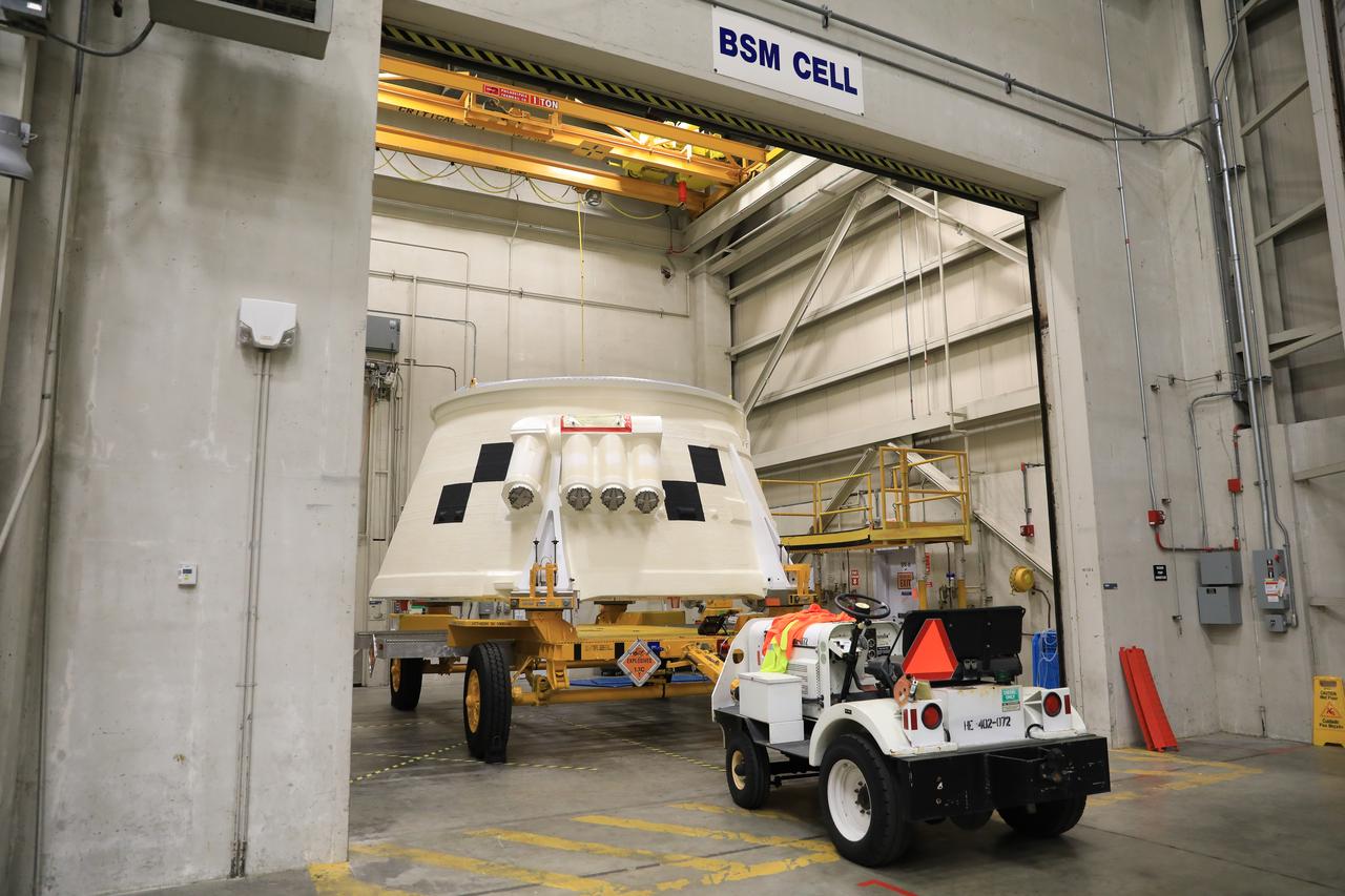 Inside the Booster Fabrication Facility at NASA's Kennedy Space Center in Florida, the Artemis I aft skirts for the agency's Space Launch System (SLS) rocket’s twin solid rocket boosters are being readied for their move to the Rotation, Processing and Surge Facility (RPSF) on June 9, 2020. In view, the left aft skirt assembly is attached to a move vehicle in a test cell. The aft skirts were refurbished by Northrop Grumman. They house the thrust vector control system, which controls 70 percent of the steering during initial ascent of the SLS rocket. The segments will remain in the RPSF until ready for stacking with the forward and aft parts of the boosters on the mobile launcher in High Bay 3 of the Vehicle Assembly Building. Through the Artemis Program, NASA is working to land the first woman and next man on the Moon by 2024.
