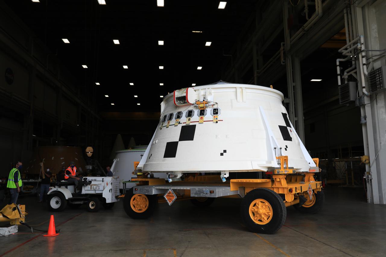 Inside the Booster Fabrication Facility at NASA's Kennedy Space Center in Florida, the Artemis I aft skirts for the agency's Space Launch System (SLS) rocket’s twin solid rocket boosters are being readied for their move to the Rotation, Processing and Surge Facility (RPSF) on June 9, 2020. In view, the left aft skirt assembly is attached to a move vehicle and moved out of a test cell. The aft skirts were refurbished by Northrop Grumman. They house the thrust vector control system, which controls 70 percent of the steering during initial ascent of the SLS rocket. The segments will remain in the RPSF until ready for stacking with the forward and aft parts of the boosters on the mobile launcher in High Bay 3 of the Vehicle Assembly Building. Through the Artemis Program, NASA is working to land the first woman and next man on the Moon by 2024. 