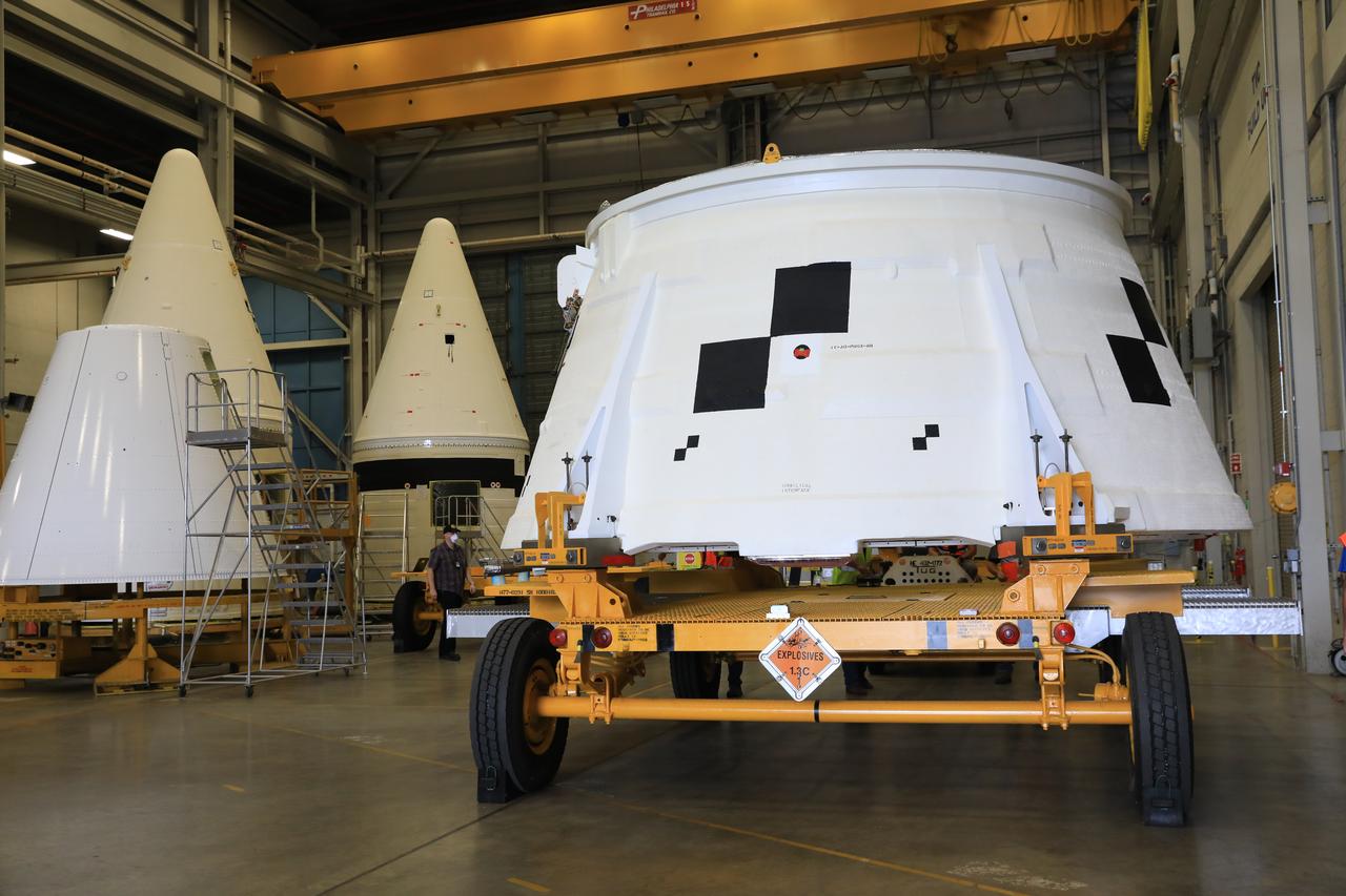 Inside the Booster Fabrication Facility at NASA's Kennedy Space Center in Florida, the Artemis I aft skirts for the agency's Space Launch System (SLS) rocket’s twin solid rocket boosters are moved out of their test cells and are being readied for their move to the Rotation, Processing and Surge Facility (RPSF) on June 9, 2020. In view at right is the right aft skirt. In view at left are the two Artemis I forward assemblies. The aft skirts were refurbished by Northrop Grumman. They house the thrust vector control system, which controls 70 percent of the steering during initial ascent of the SLS rocket. The segments will remain in the RPSF until ready for stacking with the forward and aft parts of the boosters on the mobile launcher in High Bay 3 of the Vehicle Assembly Building. Through the Artemis Program, NASA is working to land the first woman and next man on the Moon by 2024.
