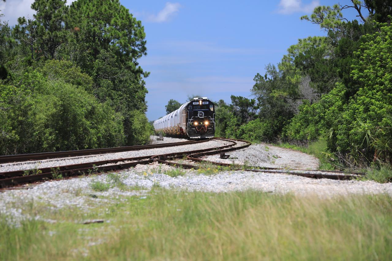 The train carrying the two solid rocket boosters that will power NASA’s Space Launch System (SLS) for Artemis missions to the Moon arrives at the Jay Jay rail yard – the connecting link between Kennedy Space Center and the Florida East Coast railway – in Titusville, Florida, on June 12, 2020. The boosters, each comprised of five motor segments, traveled from a Northrop Grumman manufacturing facility in Promontory, Utah, to Kennedy’s Rotation, Processing and Surge Facility, where teams with NASA’s Exploration Ground Systems will process the segments before moving them to the Vehicle Assembly Building for stacking on the mobile launcher. Under the Artemis program, NASA will land the first woman and the next man on the Moon by 2024. The first in a series of increasingly complex missions, Artemis I will test the Orion spacecraft and SLS as an integrated system ahead of crewed flights to the Moon.  