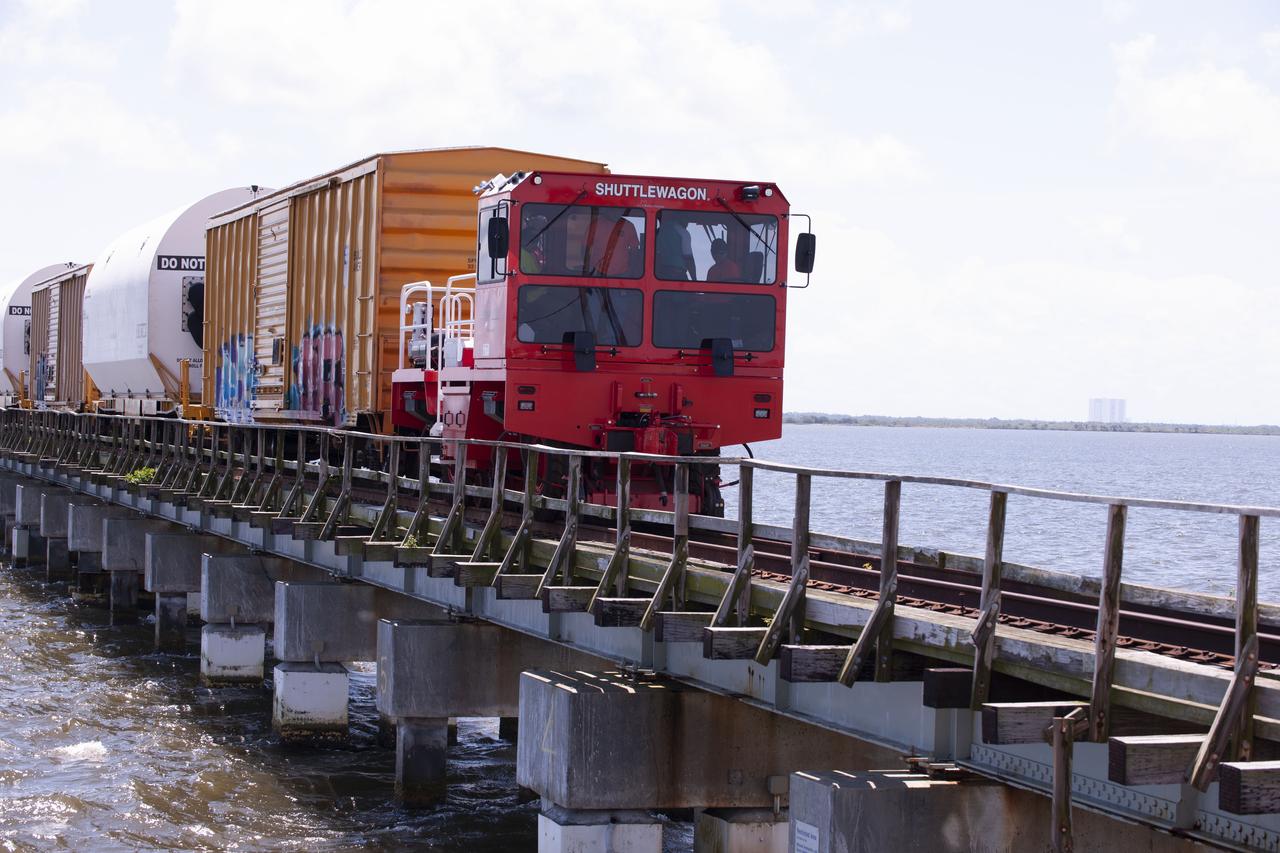 Twin rocket boosters for NASA’s Space Launch System (SLS) that will power Artemis missions to the Moon have arrived at the agency’s Kennedy Space Center in Florida. The two motor segments, each comprised of five segments, arrived at Kennedy’s Rotation, Processing and Surge Facility (RPSF) on June 15, 2020, by train from a Northrop Grumman manufacturing facility in Promontory, Utah. The booster segments will remain in the RPSF for inspection prior to processing until it’s time to move them to the Vehicle Assembly Building for stacking on the mobile launcher. This is the first piece of flight hardware to arrive at Kennedy by train for the Artemis program, but NASA’s Exploration Ground Systems (EGS) can expect to receive additional hardware soon, including the Launch Vehicle Service Adapter and the rocket’s core stage. NASA is working toward an Artemis I launch date in 2021, keeping the program moving at the best possible pace toward the earliest possible opportunity.  