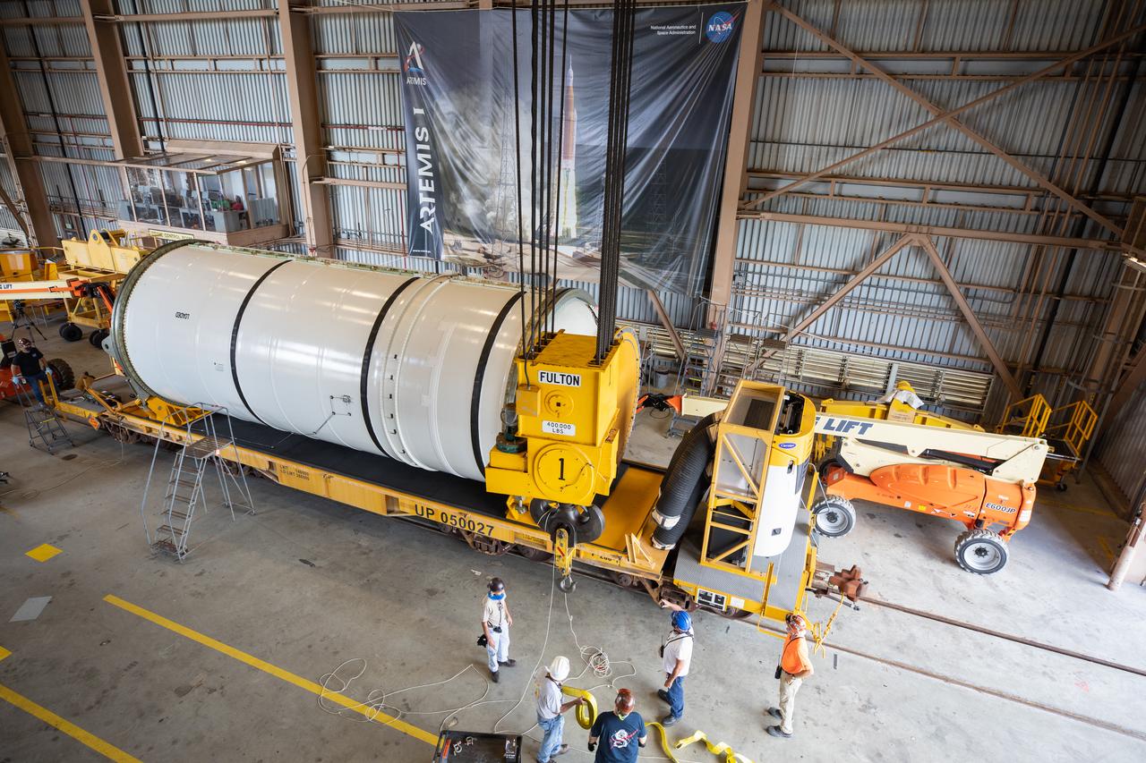 Technicians ready two NASA Space Launch System (SLS) solid rocket boosters for mating to the rocket’s two aft skirts on June 16, 2020, inside Kennedy Space Center’s Rotation, Processing and Surge Facility. Together, the twin boosters provide more than 75 percent of the total SLS thrust at launch. Manufactured by Northrop Grumman in Promontory, Utah, the boosters arrived at Kennedy via train. The cross-country journey was an important milestone for the agency’s Artemis I launch. The first in a series of increasingly complex missions, Artemis I will test the Orion spacecraft and SLS as an integrated system prior to crewed missions to the Moon. Once the boosters are mated with the aft skirts, they will be moved to the Vehicle Assembly Building for stacking on the mobile launcher.