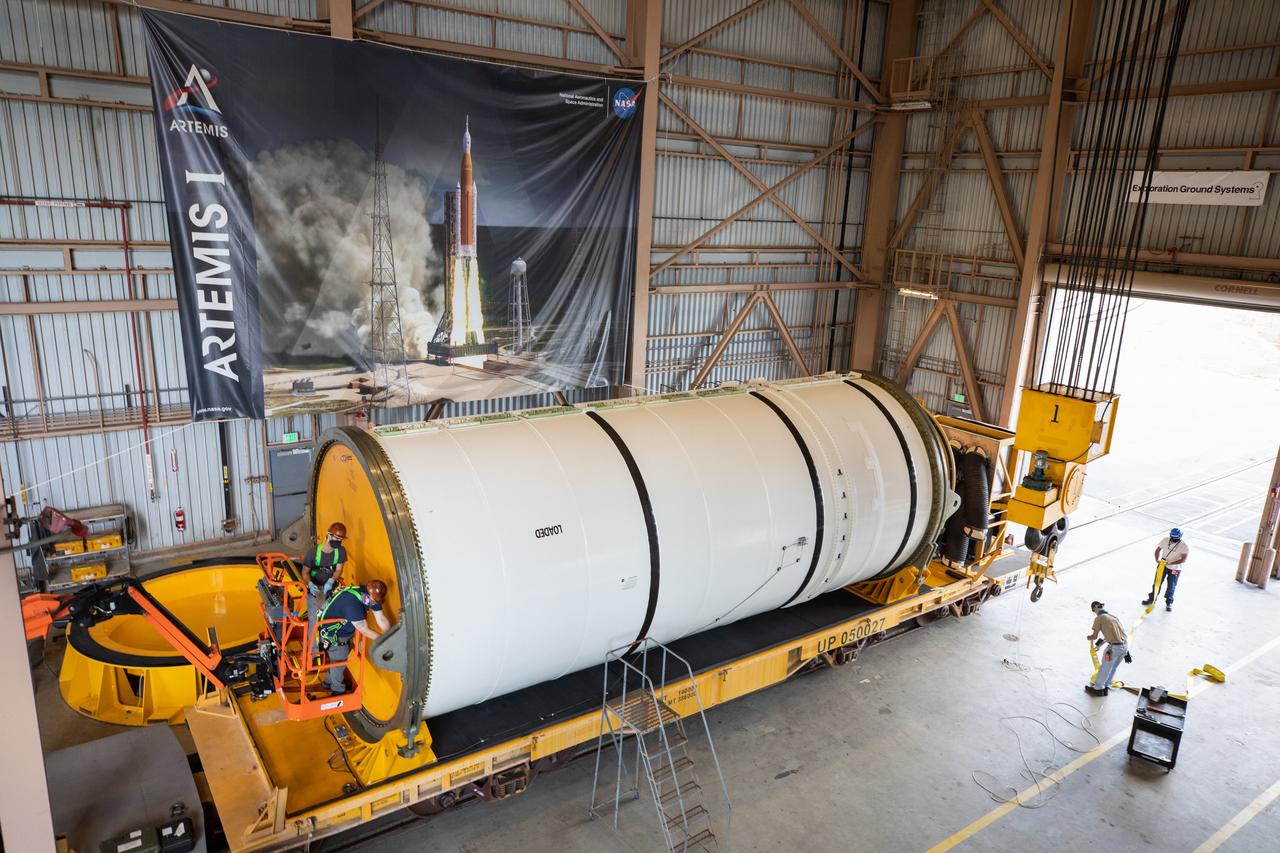 Technicians ready two NASA Space Launch System (SLS) solid rocket boosters for mating to the rocket’s two aft skirts on June 16, 2020, inside Kennedy Space Center’s Rotation, Processing and Surge Facility. Together, the twin boosters provide more than 75 percent of the total SLS thrust at launch. Manufactured by Northrop Grumman in Promontory, Utah, the boosters arrived at Kennedy via train. The cross-country journey was an important milestone for the agency’s Artemis I launch. The first in a series of increasingly complex missions, Artemis I will test the Orion spacecraft and SLS as an integrated system prior to crewed missions to the Moon. Once the boosters are mated with the aft skirts, they will be moved to the Vehicle Assembly Building for stacking on the mobile launcher.