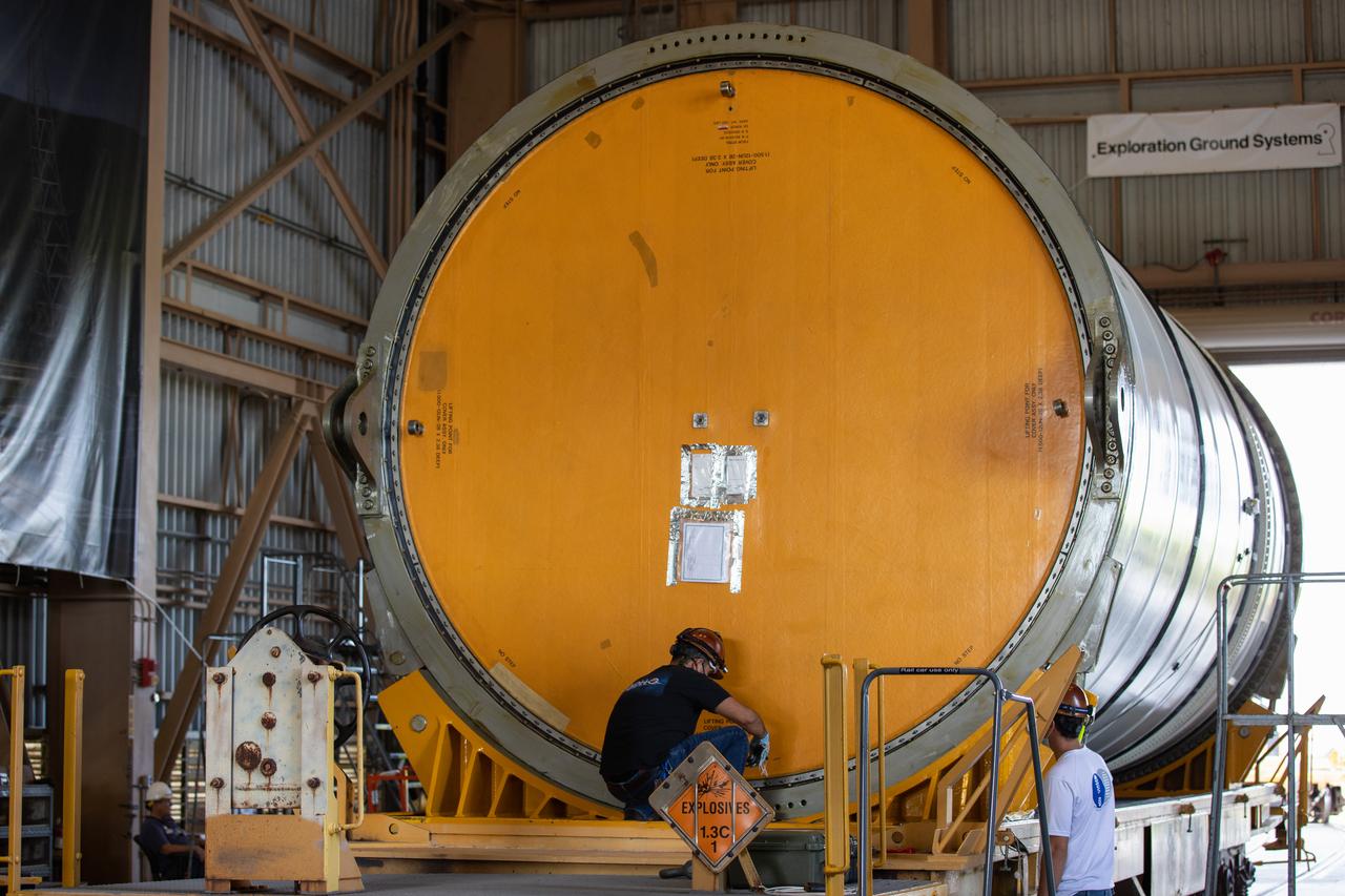 Technicians ready two NASA Space Launch System (SLS) solid rocket boosters for mating to the rocket’s two aft skirts on June 16, 2020, inside Kennedy Space Center’s Rotation, Processing and Surge Facility. Together, the twin boosters provide more than 75 percent of the total SLS thrust at launch. Manufactured by Northrop Grumman in Promontory, Utah, the boosters arrived at Kennedy via train. The cross-country journey was an important milestone for the agency’s Artemis I launch. The first in a series of increasingly complex missions, Artemis I will test the Orion spacecraft and SLS as an integrated system prior to crewed missions to the Moon. Once the boosters are mated with the aft skirts, they will be moved to the Vehicle Assembly Building for stacking on the mobile launcher.