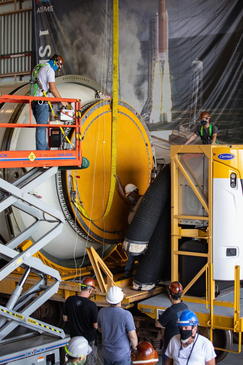 Technicians ready two NASA Space Launch System (SLS) solid rocket boosters for mating to the rocket’s two aft skirts on June 16, 2020, inside Kennedy Space Center’s Rotation, Processing and Surge Facility. Together, the twin boosters provide more than 75 percent of the total SLS thrust at launch. Manufactured by Northrop Grumman in Promontory, Utah, the boosters arrived at Kennedy via train. The cross-country journey was an important milestone for the agency’s Artemis I launch. The first in a series of increasingly complex missions, Artemis I will test the Orion spacecraft and SLS as an integrated system prior to crewed missions to the Moon. Once the boosters are mated with the aft skirts, they will be moved to the Vehicle Assembly Building for stacking on the mobile launcher.