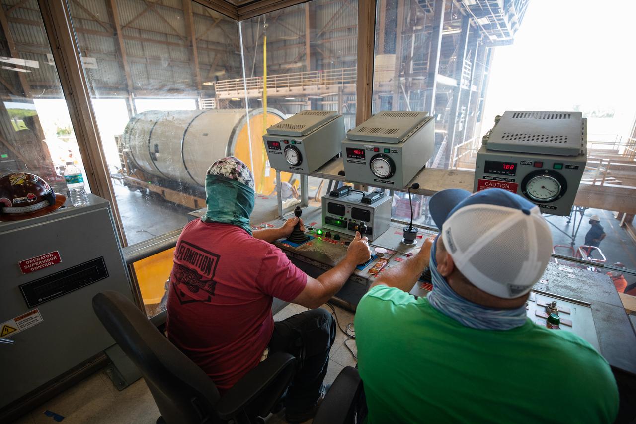Technicians ready two NASA Space Launch System (SLS) solid rocket boosters for mating to the rocket’s two aft skirts on June 16, 2020, inside Kennedy Space Center’s Rotation, Processing and Surge Facility. Together, the twin boosters provide more than 75 percent of the total SLS thrust at launch. Manufactured by Northrop Grumman in Promontory, Utah, the boosters arrived at Kennedy via train. The cross-country journey was an important milestone for the agency’s Artemis I launch. The first in a series of increasingly complex missions, Artemis I will test the Orion spacecraft and SLS as an integrated system prior to crewed missions to the Moon. Once the boosters are mated with the aft skirts, they will be moved to the Vehicle Assembly Building for stacking on the mobile launcher.