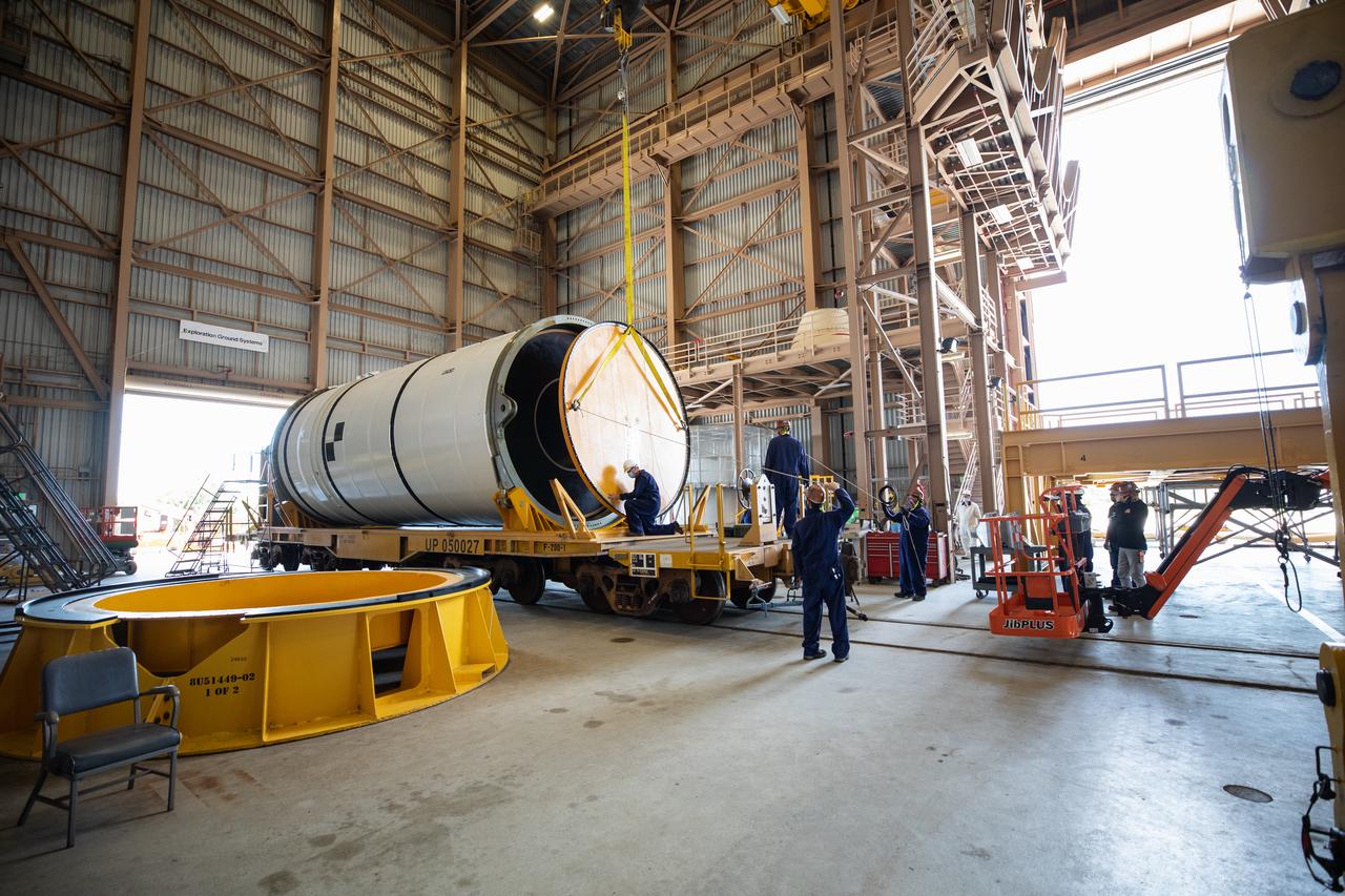 Technicians ready two NASA Space Launch System (SLS) solid rocket boosters for mating to the rocket’s two aft skirts on June 16, 2020, inside Kennedy Space Center’s Rotation, Processing and Surge Facility. Together, the twin boosters provide more than 75 percent of the total SLS thrust at launch. Manufactured by Northrop Grumman in Promontory, Utah, the boosters arrived at Kennedy via train. The cross-country journey was an important milestone for the agency’s Artemis I launch. The first in a series of increasingly complex missions, Artemis I will test the Orion spacecraft and SLS as an integrated system prior to crewed missions to the Moon. Once the boosters are mated with the aft skirts, they will be moved to the Vehicle Assembly Building for stacking on the mobile launcher.