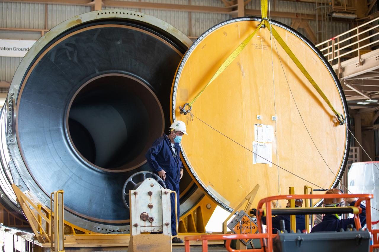 Technicians ready two NASA Space Launch System (SLS) solid rocket boosters for mating to the rocket’s two aft skirts on June 16, 2020, inside Kennedy Space Center’s Rotation, Processing and Surge Facility. Together, the twin boosters provide more than 75 percent of the total SLS thrust at launch. Manufactured by Northrop Grumman in Promontory, Utah, the boosters arrived at Kennedy via train. The cross-country journey was an important milestone for the agency’s Artemis I launch. The first in a series of increasingly complex missions, Artemis I will test the Orion spacecraft and SLS as an integrated system prior to crewed missions to the Moon. Once the boosters are mated with the aft skirts, they will be moved to the Vehicle Assembly Building for stacking on the mobile launcher.