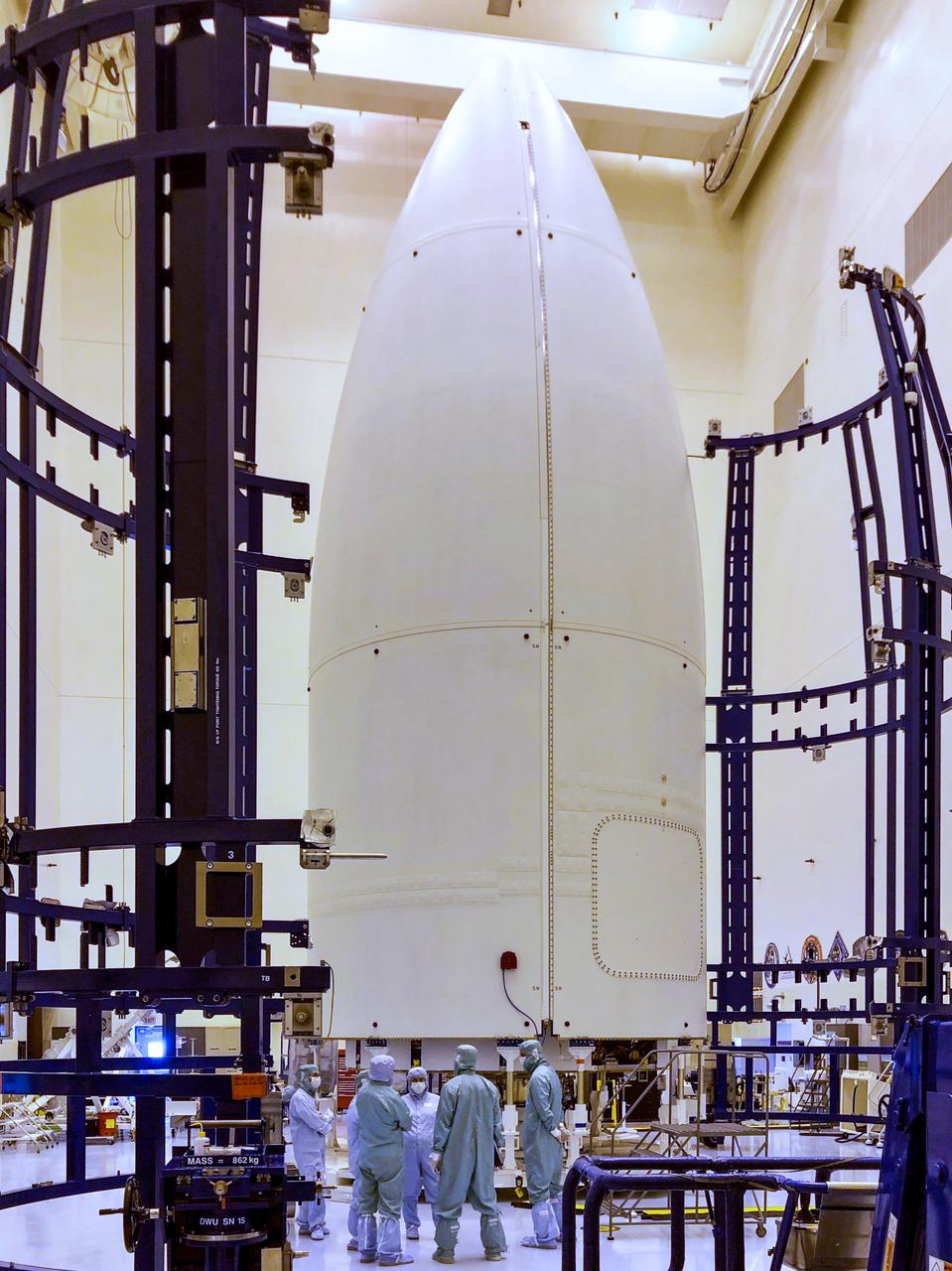 Inside the Payload Hazardous Servicing Facility at NASA’s Kennedy Space Center in Florida, the handling fixture is moved away from the two halves of the United Launch Alliance Atlas V payload fairing on June 18, 2020. Inside the fairing is the agency’s Mars 2020 Perseverance rover. The rover is scheduled to launch on July 20, 2020, atop the Atlas V 541 rocket from Space Launch Complex 41 at Cape Canaveral Air Force Station. The rover is part of NASA’s Mars Exploration Program, a long-term effort of robotic exploration of the Red Planet. The rover’s seven instruments will search for habitable conditions in the ancient past and signs of past microbial life on Mars. The Launch Services Program at Kennedy is responsible for launch management.