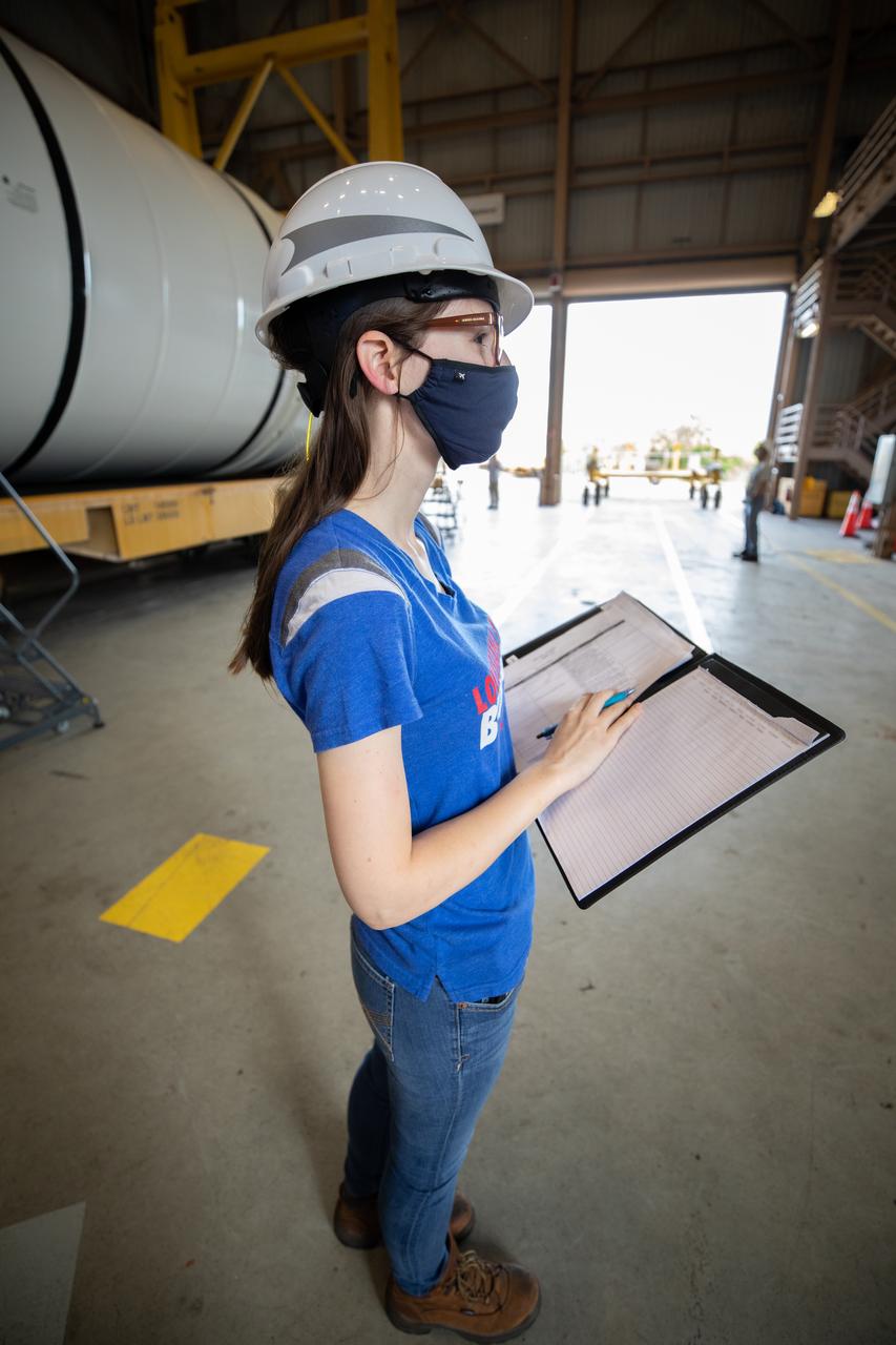 Beverly Case, a handling engineer on the Test, Operations and Support Contract at NASA’s Kennedy Space Center in Florida, readies the Space Launch System (SLS) solid rocket boosters for mating to the rocket’s two aft skirts on June 19, 2020, inside Kennedy’s Rotation, Processing and Surge Facility. Together, the twin boosters provide more than 75 percent of the total SLS thrust at launch. Manufactured by Northrop Grumman in Promontory, Utah, the boosters arrived at Kennedy via train. This cross-country journey was an important milestone for the agency’s Artemis I launch. The first in a series of increasingly complex missions, Artemis I will test the Orion spacecraft and SLS as an integrated system prior to crewed missions to the Moon. Once the boosters are mated with the aft skirts, they will be moved to the Vehicle Assembly Building for stacking on the mobile launcher.