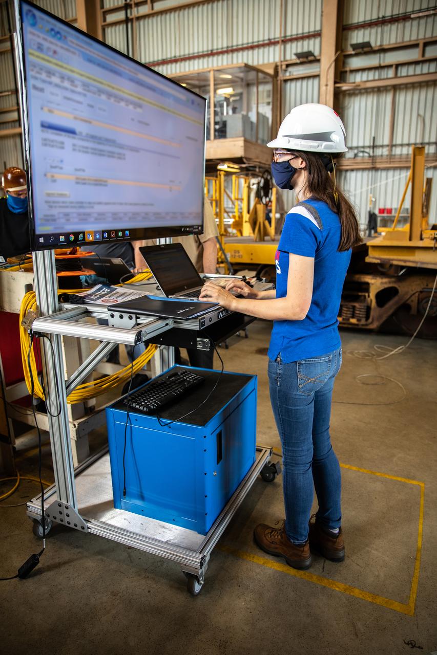 Beverly Case, a handling engineer on the Test, Operations and Support Contract at NASA’s Kennedy Space Center in Florida, readies the Space Launch System (SLS) solid rocket boosters for mating to the rocket’s two aft skirts on June 19, 2020, inside Kennedy’s Rotation, Processing and Surge Facility. Together, the twin boosters provide more than 75 percent of the total SLS thrust at launch. Manufactured by Northrop Grumman in Promontory, Utah, the boosters arrived at Kennedy via train. This cross-country journey was an important milestone for the agency’s Artemis I launch. The first in a series of increasingly complex missions, Artemis I will test the Orion spacecraft and SLS as an integrated system prior to crewed missions to the Moon. Once the boosters are mated with the aft skirts, they will be moved to the Vehicle Assembly Building for stacking on the mobile launcher.