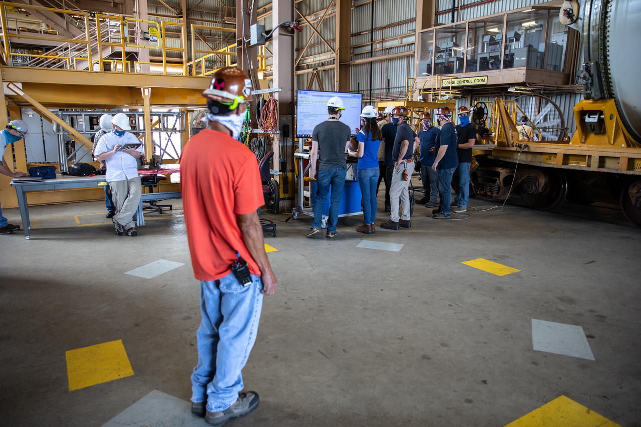 Technicians ready two NASA Space Launch System (SLS) solid rocket boosters for mating to the rocket’s two aft skirts on June 19, 2020, inside Kennedy Space Center’s Rotation, Processing and Surge Facility. Together, the twin boosters provide more than 75 percent of the total SLS thrust at launch. Manufactured by Northrop Grumman in Promontory, Utah, the boosters arrived at Kennedy via train. The cross-country journey was an important milestone for the agency’s Artemis I launch. The first in a series of increasingly complex missions, Artemis I will test the Orion spacecraft and SLS as an integrated system prior to crewed missions to the Moon. Once the boosters are mated with the aft skirts, they will be moved to the Vehicle Assembly Building for stacking on the mobile launcher.
