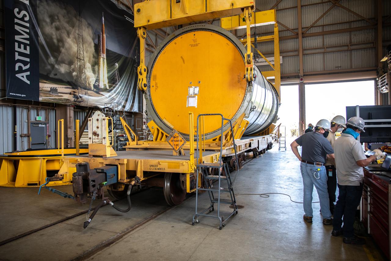 Technicians ready two NASA Space Launch System (SLS) solid rocket boosters for mating to the rocket’s two aft skirts on June 19, 2020, inside Kennedy Space Center’s Rotation, Processing and Surge Facility. Together, the twin boosters provide more than 75 percent of the total SLS thrust at launch. Manufactured by Northrop Grumman in Promontory, Utah, the boosters arrived at Kennedy via train. The cross-country journey was an important milestone for the agency’s Artemis I launch. The first in a series of increasingly complex missions, Artemis I will test the Orion spacecraft and SLS as an integrated system prior to crewed missions to the Moon. Once the boosters are mated with the aft skirts, they will be moved to the Vehicle Assembly Building for stacking on the mobile launcher.