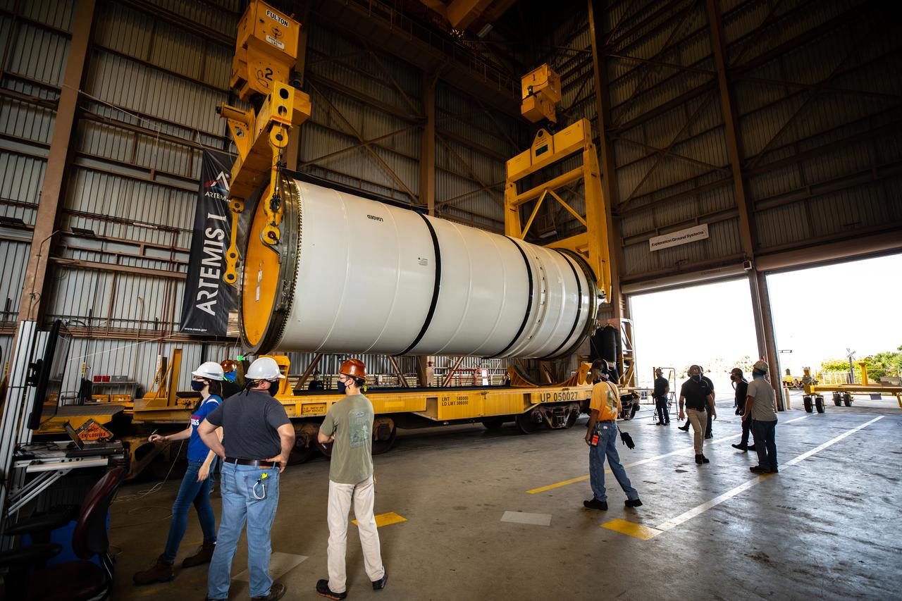 Technicians ready two NASA Space Launch System (SLS) solid rocket boosters for mating to the rocket’s two aft skirts on June 19, 2020, inside Kennedy Space Center’s Rotation, Processing and Surge Facility. Together, the twin boosters provide more than 75 percent of the total SLS thrust at launch. Manufactured by Northrop Grumman in Promontory, Utah, the boosters arrived at Kennedy via train. The cross-country journey was an important milestone for the agency’s Artemis I launch. The first in a series of increasingly complex missions, Artemis I will test the Orion spacecraft and SLS as an integrated system prior to crewed missions to the Moon. Once the boosters are mated with the aft skirts, they will be moved to the Vehicle Assembly Building for stacking on the mobile launcher.