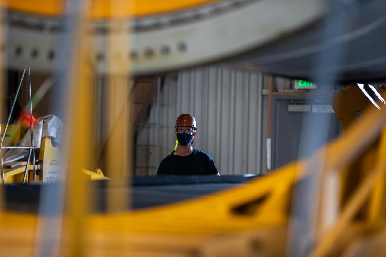 Technicians ready two NASA Space Launch System (SLS) solid rocket boosters for mating to the rocket’s two aft skirts on June 19, 2020, inside Kennedy Space Center’s Rotation, Processing and Surge Facility. Together, the twin boosters provide more than 75 percent of the total SLS thrust at launch. Manufactured by Northrop Grumman in Promontory, Utah, the boosters arrived at Kennedy via train. The cross-country journey was an important milestone for the agency’s Artemis I launch. The first in a series of increasingly complex missions, Artemis I will test the Orion spacecraft and SLS as an integrated system prior to crewed missions to the Moon. Once the boosters are mated with the aft skirts, they will be moved to the Vehicle Assembly Building for stacking on the mobile launcher.