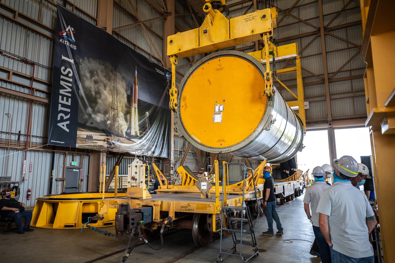 Technicians ready two NASA Space Launch System (SLS) solid rocket boosters for mating to the rocket’s two aft skirts on June 19, 2020, inside Kennedy Space Center’s Rotation, Processing and Surge Facility. Together, the twin boosters provide more than 75 percent of the total SLS thrust at launch. Manufactured by Northrop Grumman in Promontory, Utah, the boosters arrived at Kennedy via train. The cross-country journey was an important milestone for the agency’s Artemis I launch. The first in a series of increasingly complex missions, Artemis I will test the Orion spacecraft and SLS as an integrated system prior to crewed missions to the Moon. Once the boosters are mated with the aft skirts, they will be moved to the Vehicle Assembly Building for stacking on the mobile launcher.