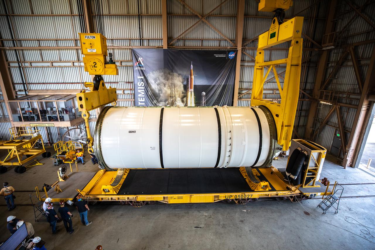 Technicians ready two NASA Space Launch System (SLS) solid rocket boosters for mating to the rocket’s two aft skirts on June 19, 2020, inside Kennedy Space Center’s Rotation, Processing and Surge Facility. Together, the twin boosters provide more than 75 percent of the total SLS thrust at launch. Manufactured by Northrop Grumman in Promontory, Utah, the boosters arrived at Kennedy via train. The cross-country journey was an important milestone for the agency’s Artemis I launch. The first in a series of increasingly complex missions, Artemis I will test the Orion spacecraft and SLS as an integrated system prior to crewed missions to the Moon. Once the boosters are mated with the aft skirts, they will be moved to the Vehicle Assembly Building for stacking on the mobile launcher.