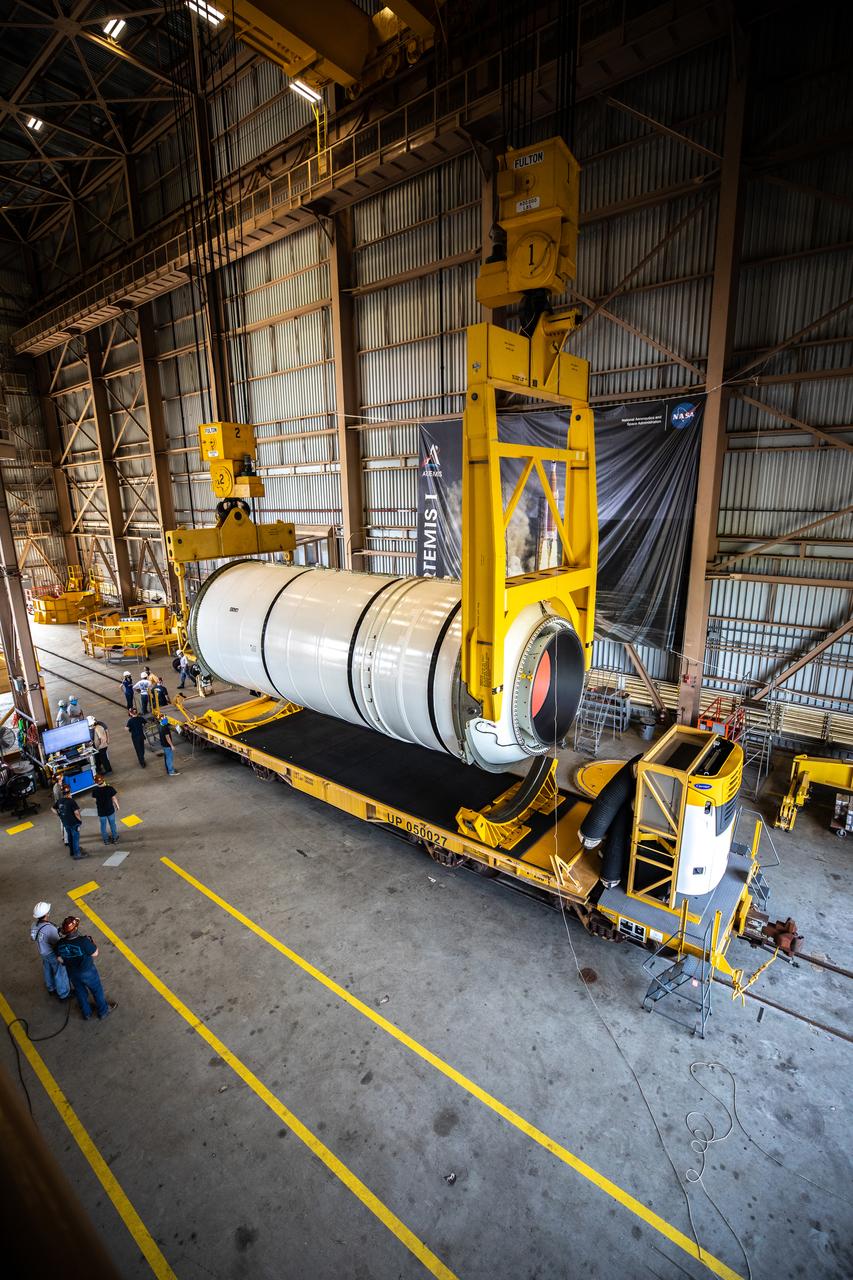 Technicians ready two NASA Space Launch System (SLS) solid rocket boosters for mating to the rocket’s two aft skirts on June 19, 2020, inside Kennedy Space Center’s Rotation, Processing and Surge Facility. Together, the twin boosters provide more than 75 percent of the total SLS thrust at launch. Manufactured by Northrop Grumman in Promontory, Utah, the boosters arrived at Kennedy via train. The cross-country journey was an important milestone for the agency’s Artemis I launch. The first in a series of increasingly complex missions, Artemis I will test the Orion spacecraft and SLS as an integrated system prior to crewed missions to the Moon. Once the boosters are mated with the aft skirts, they will be moved to the Vehicle Assembly Building for stacking on the mobile launcher.