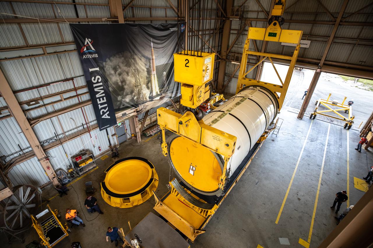 Technicians ready two NASA Space Launch System (SLS) solid rocket boosters for mating to the rocket’s two aft skirts on June 19, 2020, inside Kennedy Space Center’s Rotation, Processing and Surge Facility. Together, the twin boosters provide more than 75 percent of the total SLS thrust at launch. Manufactured by Northrop Grumman in Promontory, Utah, the boosters arrived at Kennedy via train. The cross-country journey was an important milestone for the agency’s Artemis I launch. The first in a series of increasingly complex missions, Artemis I will test the Orion spacecraft and SLS as an integrated system prior to crewed missions to the Moon. Once the boosters are mated with the aft skirts, they will be moved to the Vehicle Assembly Building for stacking on the mobile launcher.