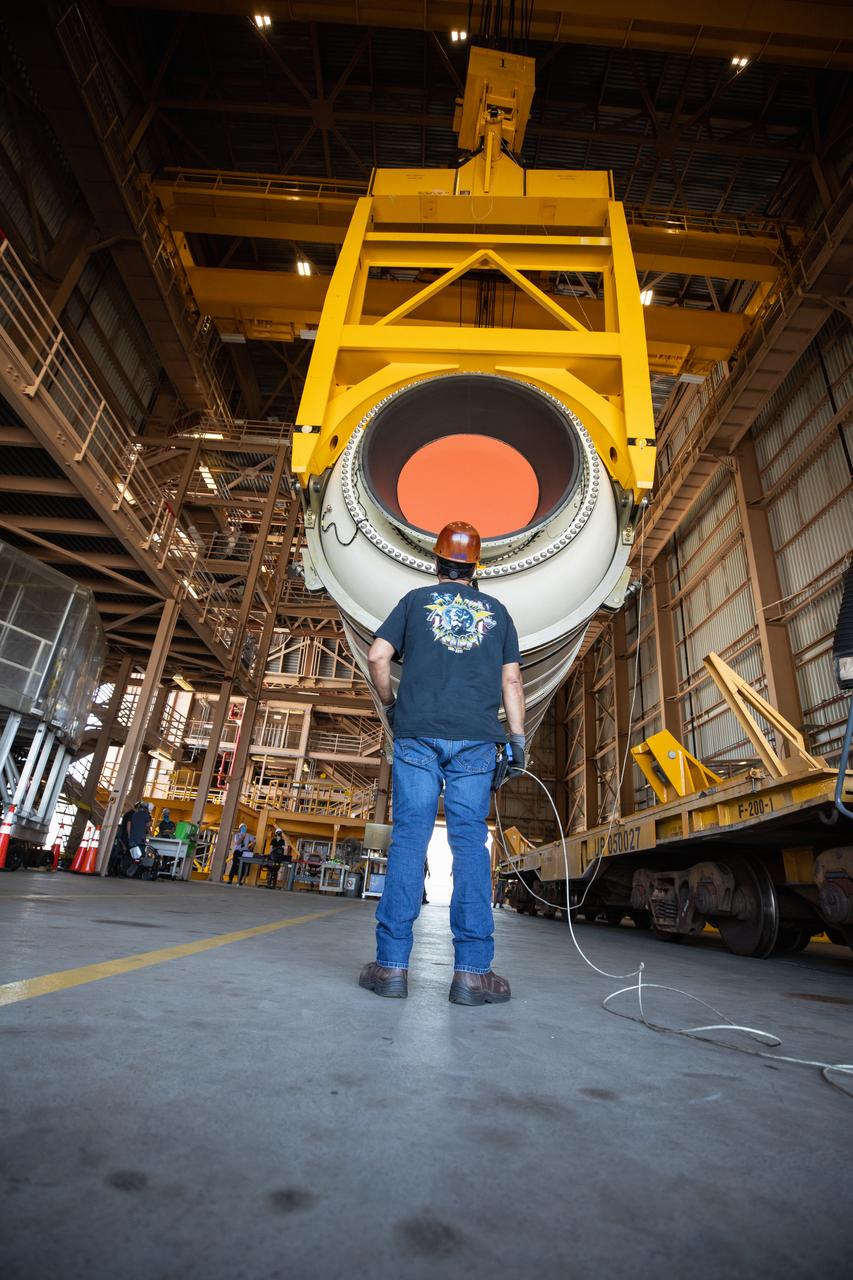 Inside the Rotation, Processing and Surge Facility (RPSF) at NASA’s Kennedy Space Center in Florida, technicians lift the right aft motor segment – one of five segments that make up one of two solid rocket boosters for the agency’s Space Launch System (SLS) – onto an inspection stand on June 23, 2020. While in the RPSF, the boosters will be mated to the rocket’s two aft skirts before they are moved to the Vehicle Assembly Building for stacking on the mobile launcher. The boosters, manufactured by Northrop Grumman in Utah, recently arrived at Kennedy for processing ahead of the Artemis I launch. Together, the twin boosters provide more than 75 percent of the total SLS thrust at launch. The first in a series of increasingly complex missions, Artemis I will test the Orion spacecraft and SLS as an integrated system ahead of crewed flights to the Moon.  