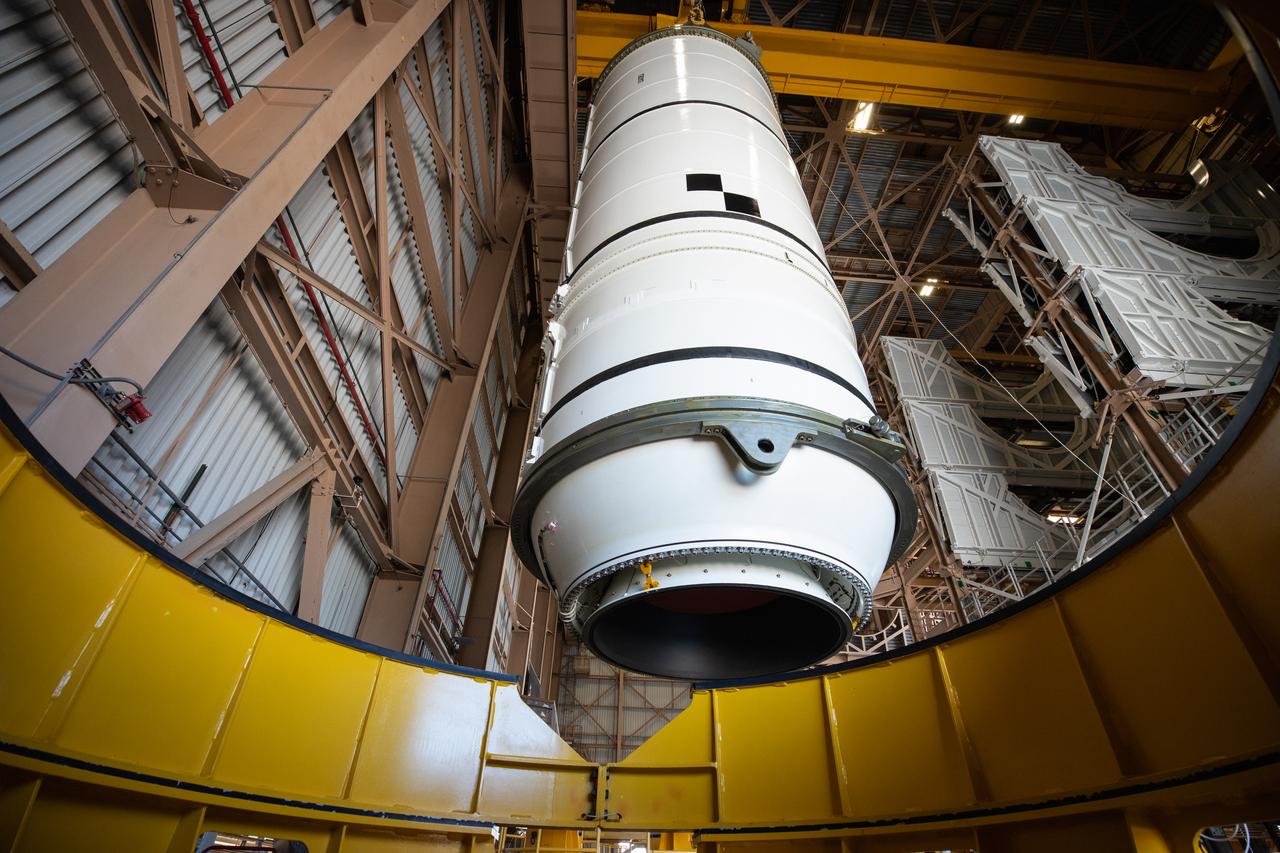 Inside the Rotation, Processing and Surge Facility (RPSF) at NASA’s Kennedy Space Center in Florida, technicians lift the right aft motor segment – one of five segments that make up one of two solid rocket boosters for the agency’s Space Launch System (SLS) – onto an inspection stand on June 23, 2020. While in the RPSF, the boosters will be mated to the rocket’s two aft skirts before they are moved to the Vehicle Assembly Building for stacking on the mobile launcher. The boosters, manufactured by Northrop Grumman in Utah, recently arrived at Kennedy for processing ahead of the Artemis I launch. Together, the twin boosters provide more than 75 percent of the total SLS thrust at launch. The first in a series of increasingly complex missions, Artemis I will test the Orion spacecraft and SLS as an integrated system ahead of crewed flights to the Moon.  