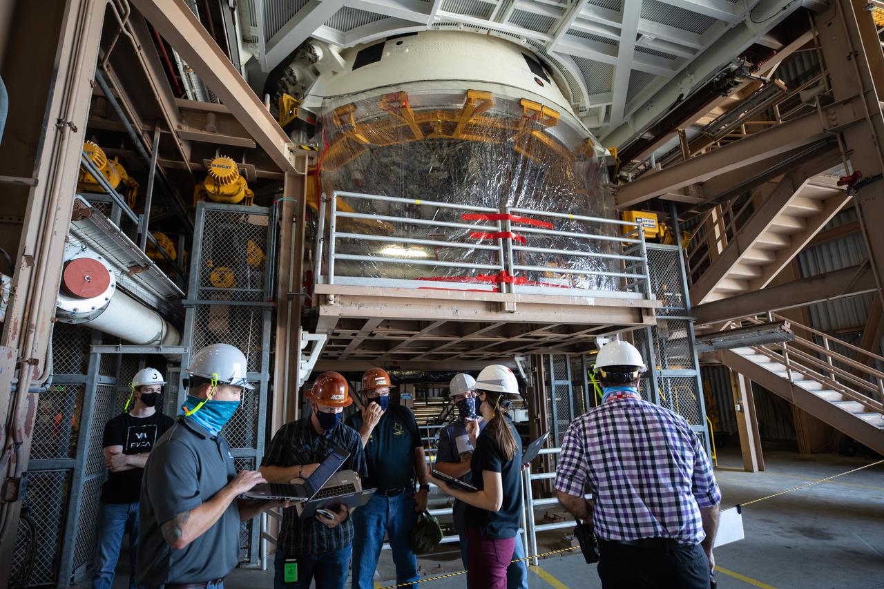Inside the Rotation, Processing and Surge Facility (RPSF) at NASA’s Kennedy Space Center in Florida, technicians lift the right aft motor segment – one of five segments that make up one of two solid rocket boosters for the agency’s Space Launch System (SLS) – onto an inspection stand on June 23, 2020. While in the RPSF, the boosters will be mated to the rocket’s two aft skirts before they are moved to the Vehicle Assembly Building for stacking on the mobile launcher. The boosters, manufactured by Northrop Grumman in Utah, recently arrived at Kennedy for processing ahead of the Artemis I launch. Together, the twin boosters provide more than 75 percent of the total SLS thrust at launch. The first in a series of increasingly complex missions, Artemis I will test the Orion spacecraft and SLS as an integrated system ahead of crewed flights to the Moon.  