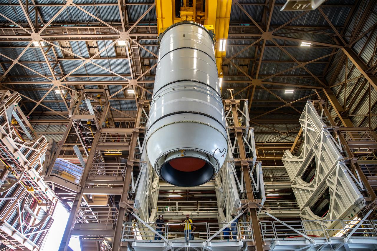 Inside the Rotation, Processing and Surge Facility at NASA’s Kennedy Space Center in Florida, technicians mate the right-hand motor segment – one of five segments that make up one of two solid rocket boosters for the agency’s Space Launch System (SLS) – to the rocket’s right-hand aft skirt on June 24, 2020. Once the aft segments are mated to the two aft skirts, they will be moved to the Vehicle Assembly Building for stacking on the mobile launcher. Manufactured by Northrop Grumman in Utah, the twin boosters provide more than 75 percent of the total SLS thrust at launch. Under the Artemis program, NASA will land the first woman and the next man on the Moon by 2024. The first in a series of increasingly complex missions, Artemis I will test the Orion spacecraft and SLS as an integrated system ahead of crewed flights to the Moon.