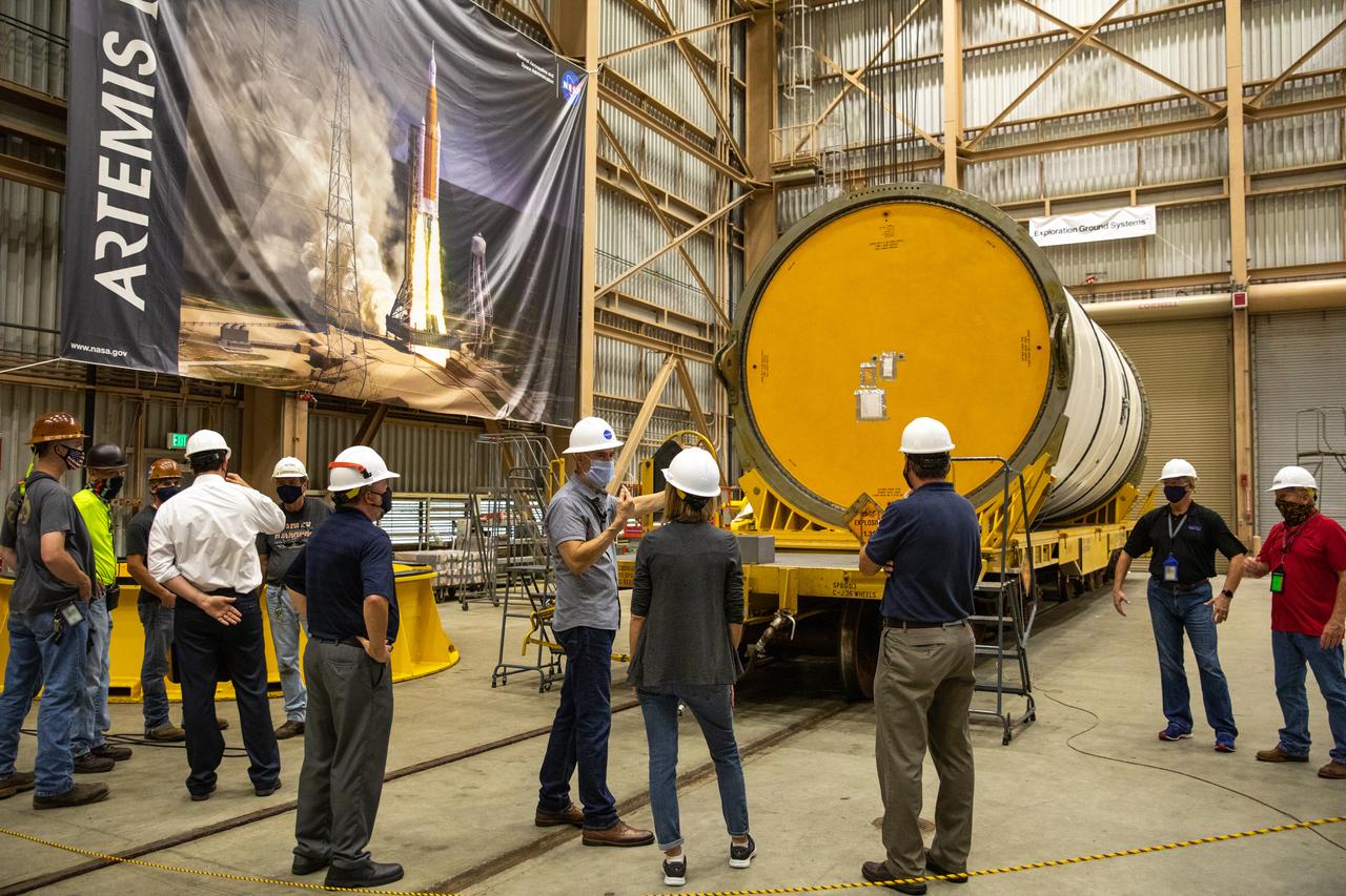 Kathy Lueders, in the center at right, NASA’s associate administrator for Human Exploration and Operations, along with members of the Exploration Ground Systems and Jacobs Technology leadership view Artemis hardware inside the Rotation, Processing and Surge Facility (RPSF) at the agency’s Kennedy Space Center in Florida on June 25, 2020. Manufactured by Northrop Grumman in Utah, the solid rocket booster segments for the Space Launch System rocket are in view. The first in a series of increasingly complex missions, Artemis I will test the Orion spacecraft and SLS as an integrated system ahead of crewed flights to the Moon.