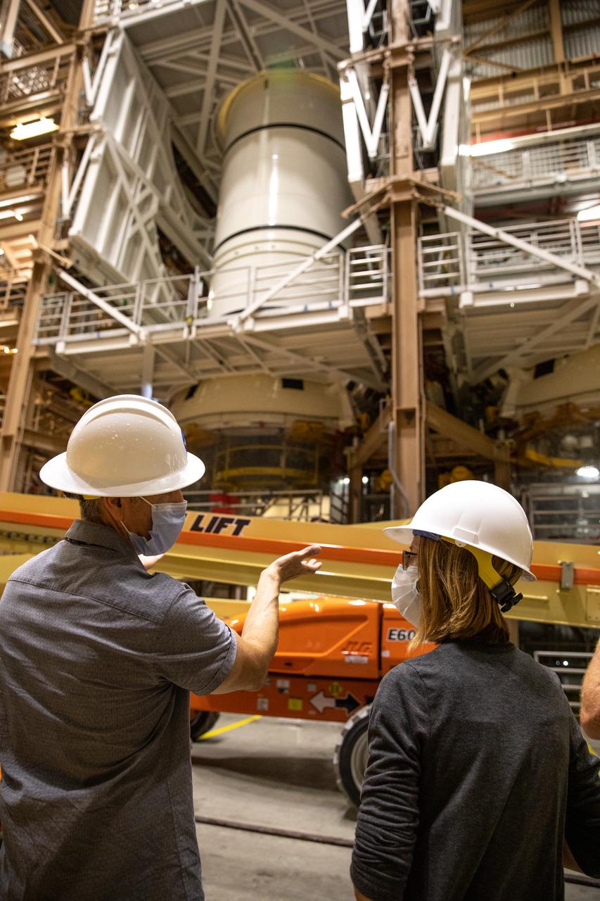 Kathy Lueders, at right, NASA’s associate administrator for Human Exploration and Operations, along with Exploration Ground Systems leadership view Artemis hardware inside the Rotation, Processing and Surge Facility (RPSF) at the agency’s Kennedy Space Center in Florida on June 25, 2020. Manufactured by Northrop Grumman in Utah, the solid rocket booster segments for the Space Launch System rocket are in view. The first in a series of increasingly complex missions, Artemis I will test the Orion spacecraft and SLS as an integrated system ahead of crewed flights to the Moon. 