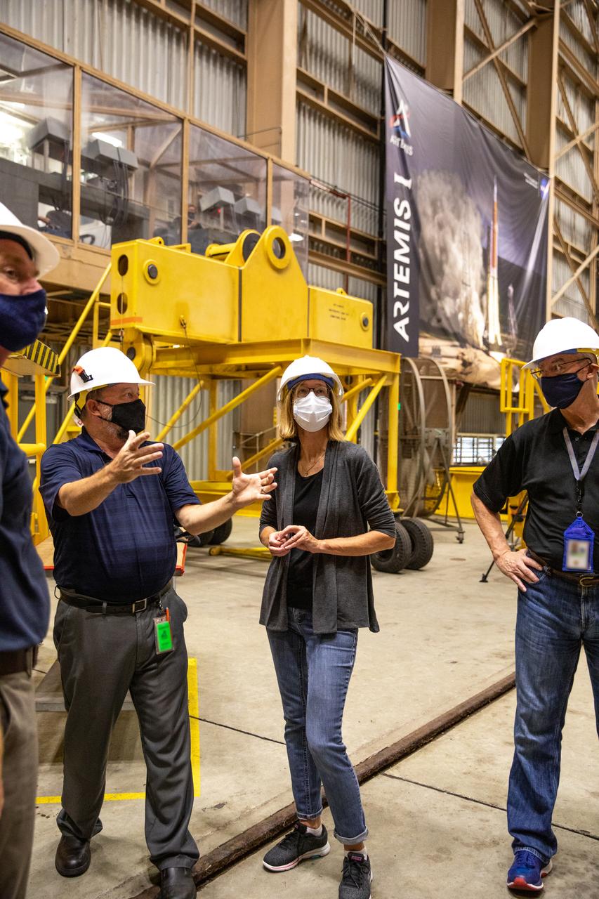 Kathy Lueders, center, NASA’s associate administrator for Human Exploration and Operations, along with members of the Exploration Ground Systems and Jacobs Technology leadership view Artemis hardware inside the Rotation, Processing and Surge Facility (RPSF) at the agency’s Kennedy Space Center in Florida on June 25, 2020. Manufactured by Northrop Grumman in Utah, the solid rocket booster segments for the Space Launch System rocket are in view. The first in a series of increasingly complex missions, Artemis I will test the Orion spacecraft and SLS as an integrated system ahead of crewed flights to the Moon.