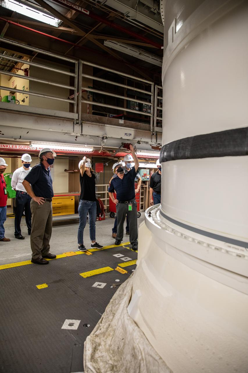 Kathy Lueders, second from right, NASA’s associate administrator for Human Exploration and Operations, along with members of the Exploration Ground Systems and Jacobs Technology leadership view Artemis hardware inside the Rotation, Processing and Surge Facility (RPSF) at the agency’s Kennedy Space Center in Florida on June 25, 2020. Manufactured by Northrop Grumman in Utah, the solid rocket booster segments for the Space Launch System rocket are in view. The first in a series of increasingly complex missions, Artemis I will test the Orion spacecraft and SLS as an integrated system ahead of crewed flights to the Moon.