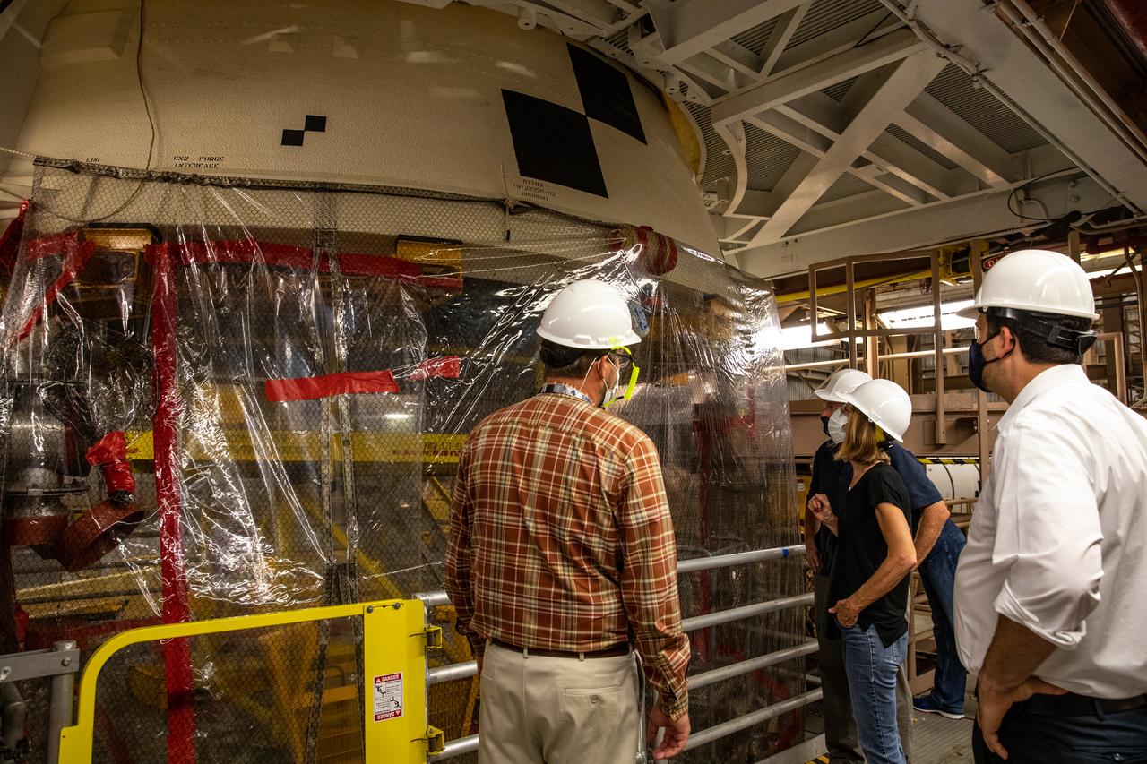 Kathy Lueders, second from right, NASA’s associate administrator for Human Exploration and Operations, along with members of the Exploration Ground Systems and Jacobs Technology leadership view Artemis hardware inside the Rotation, Processing and Surge Facility (RPSF) at the agency’s Kennedy Space Center in Florida on June 25, 2020. Manufactured by Northrop Grumman in Utah, the solid rocket booster segments for the Space Launch System rocket are in view. The first in a series of increasingly complex missions, Artemis I will test the Orion spacecraft and SLS as an integrated system ahead of crewed flights to the Moon.