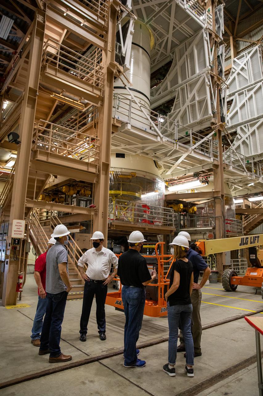 Kathy Lueders, at right, NASA’s associate administrator for Human Exploration and Operations, along with members of the Exploration Ground Systems and Jacobs Technology leadership view Artemis hardware inside the Rotation, Processing and Surge Facility (RPSF) at the agency’s Kennedy Space Center in Florida on June 25, 2020. Manufactured by Northrop Grumman in Utah, the solid rocket booster segments for the Space Launch System rocket are in view. The first in a series of increasingly complex missions, Artemis I will test the Orion spacecraft and SLS as an integrated system ahead of crewed flights to the Moon.