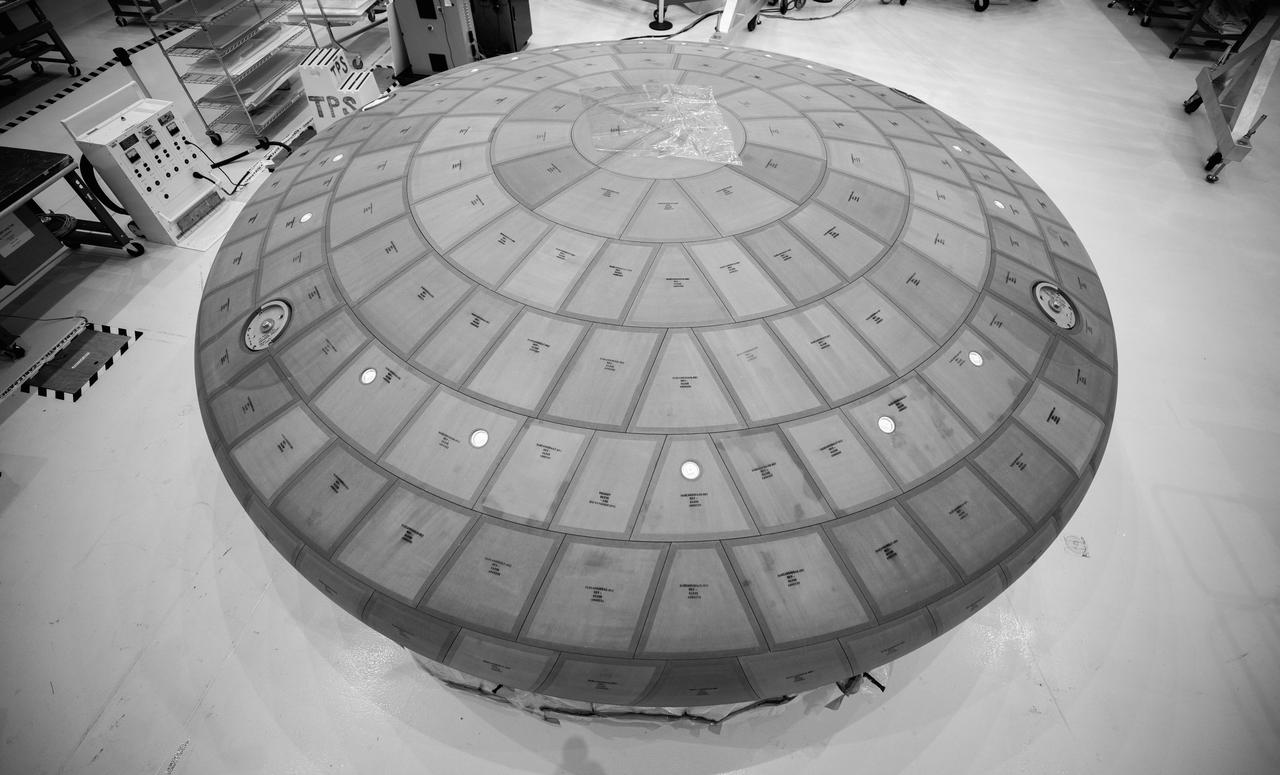 Inside the Neil Armstrong Operations and Checkout Building high bay at NASA's Kennedy Space Center in Florida, the AVOCAT block bonding is complete on the Artemis II heat shield on July 2, 2020. The heat shield is one of the most critical elements of Orion and will protect the capsule and astronauts during reentry through Earth’s atmosphere. Artemis II is the first crewed mission in a series of missions to the Moon and on to Mars. Artemis II will confirm all of the Orion spacecraft’s systems operate as designed in the actual environment of deep space with astronauts aboard. As part of the Artemis Program, NASA will send the first woman and next man to the Moon by 2024.