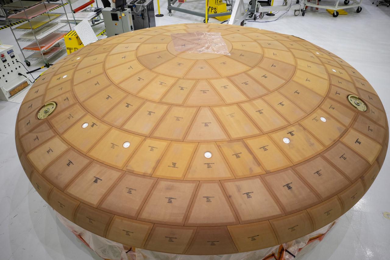 Inside the Neil Armstrong Operations and Checkout Building high bay at NASA's Kennedy Space Center in Florida, the AVCOAT block bonding is complete on the Artemis II heat shield on July 2, 2020. The heat shield is one of the most critical elements of Orion and will protect the capsule and astronauts during reentry through Earth’s atmosphere. Artemis II is the first crewed mission in a series of missions to the Moon and on to Mars. Artemis II will confirm all of the Orion spacecraft’s systems operate as designed in the actual environment of deep space with astronauts aboard. As part of the Artemis Program, NASA will send the first woman and next man to the Moon by 2024.